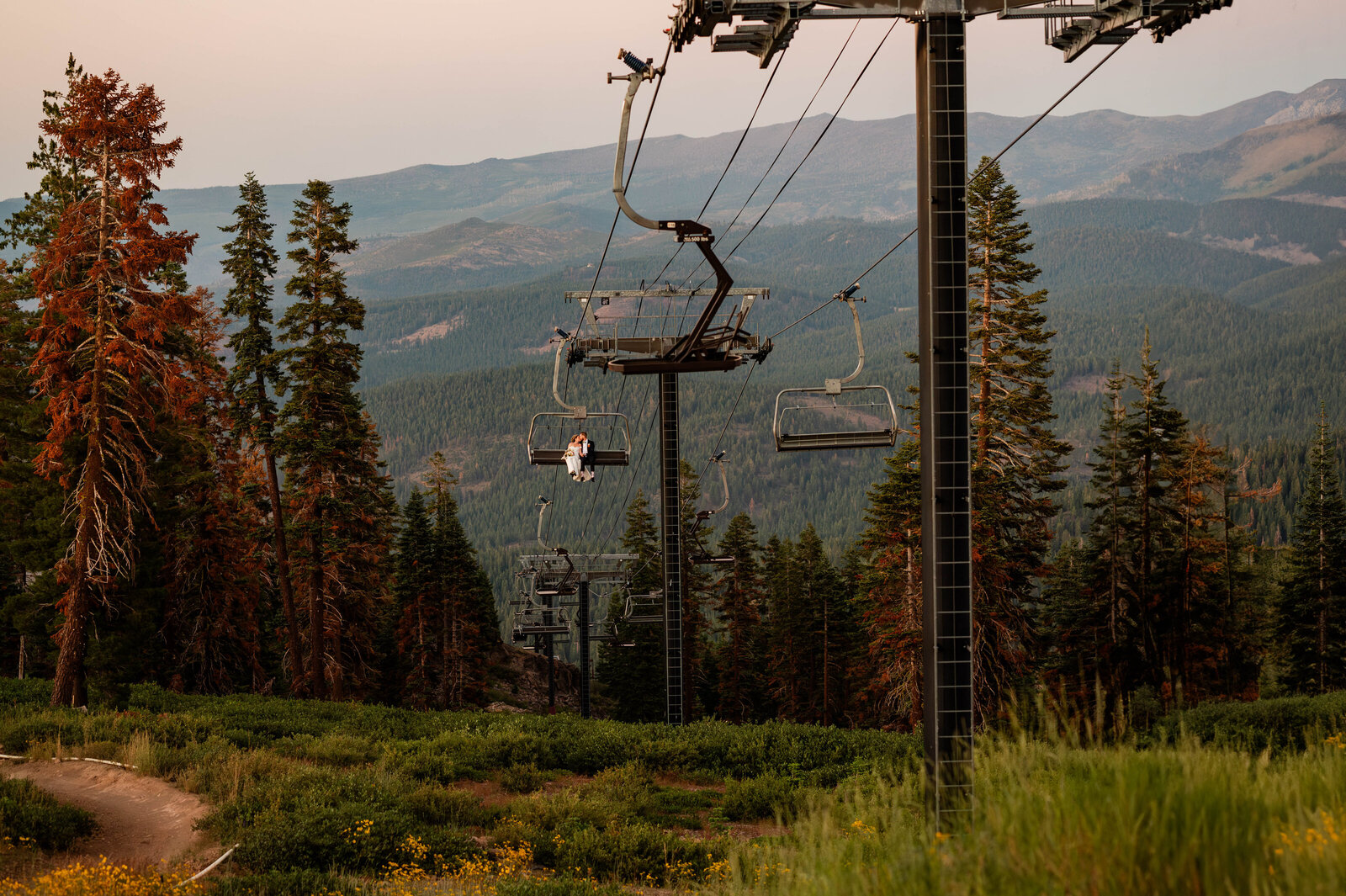 A wedding couple riding the ski lift in Lake Tahoe California