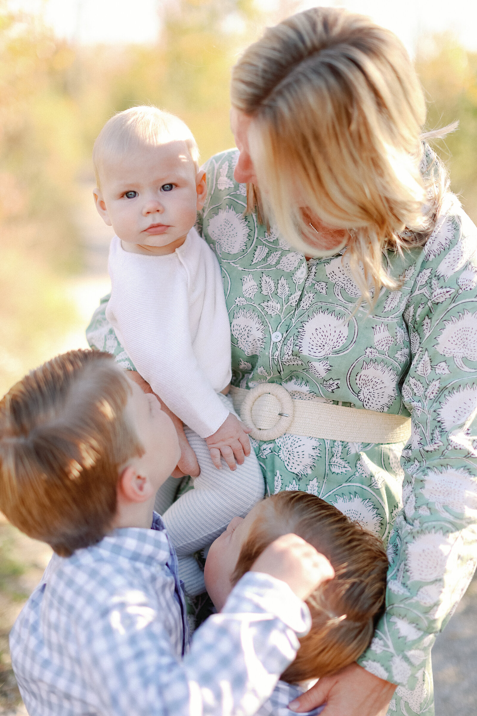 boys all hugging their mother during fall family photos