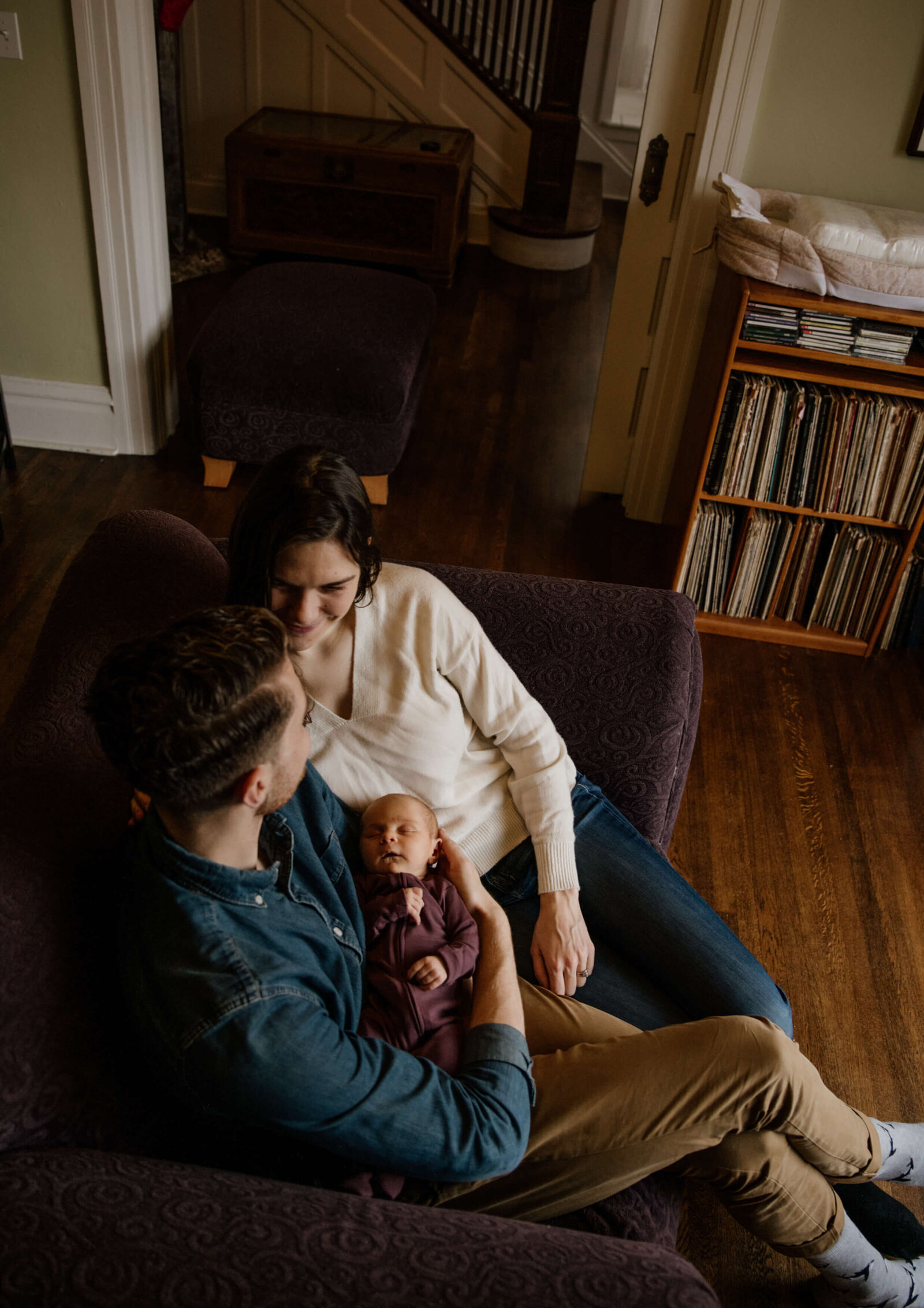 Couple in their home with baby.