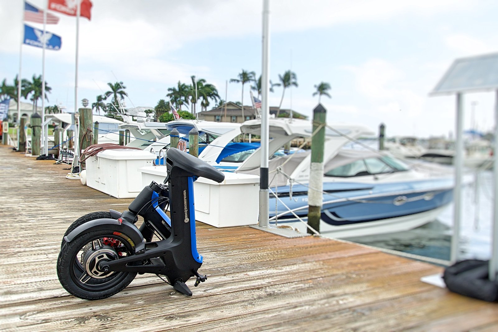 Blue Folded Go-Bike M3 with boat in background
