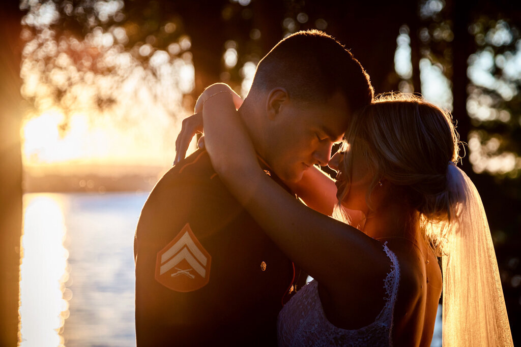 Couple on wedding day embracing for a quiet moment at  sunset