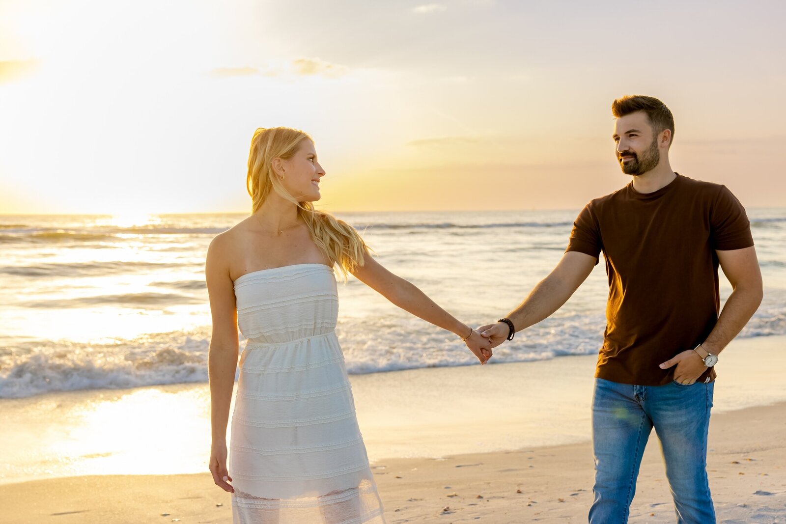 Couple walking on the beach after getting engaged on Anna Maria Island