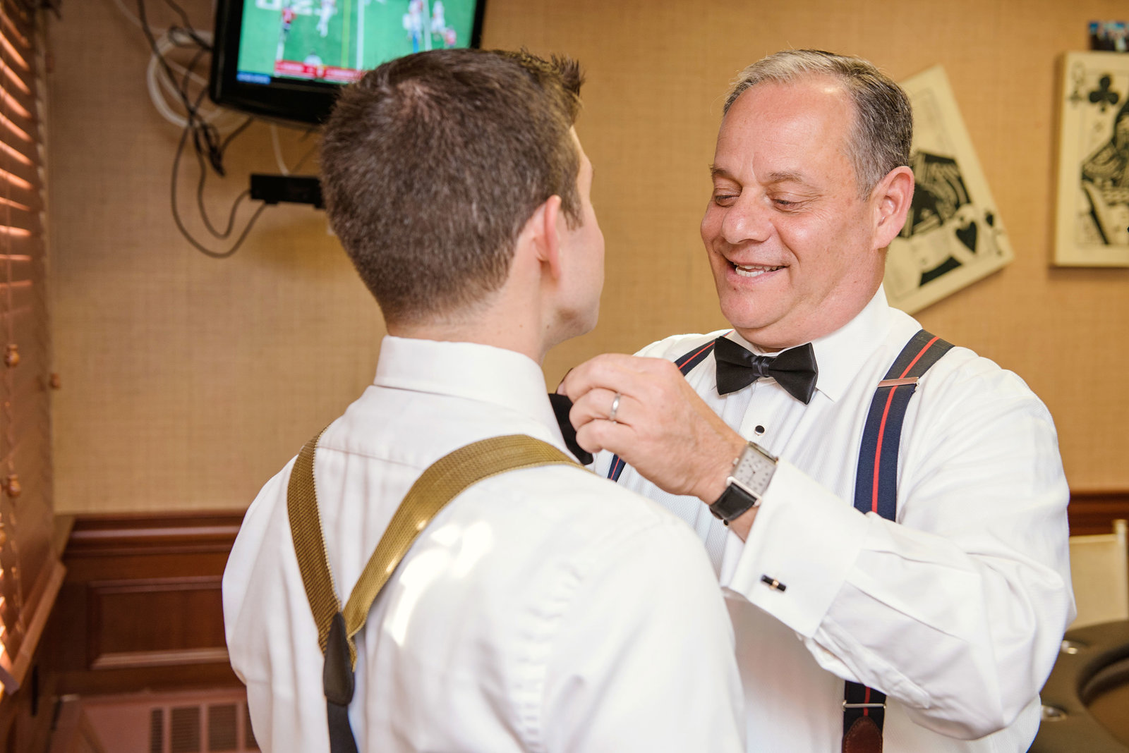 groom getting help with his bowtie at Glen Head Country Club