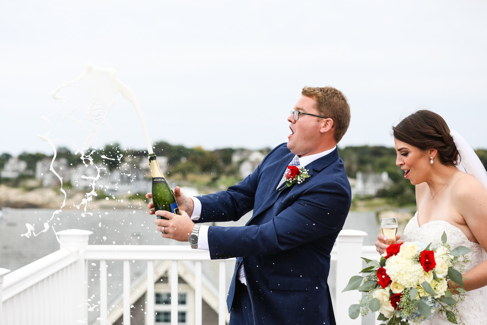 couple opens champagne bottle on roof