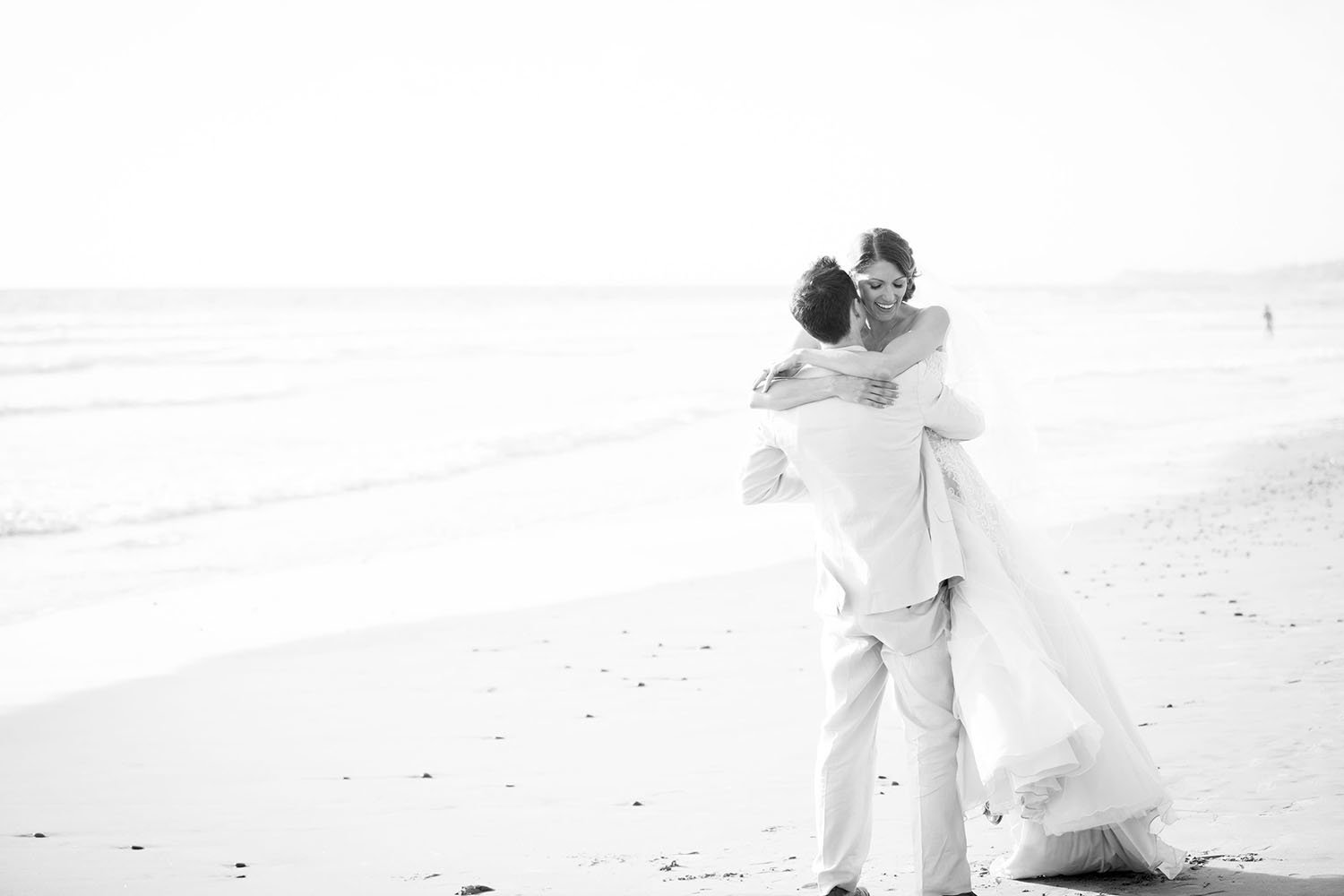 Bride and groom on the beach in Del Mar | L'Auberge Wedding Photos