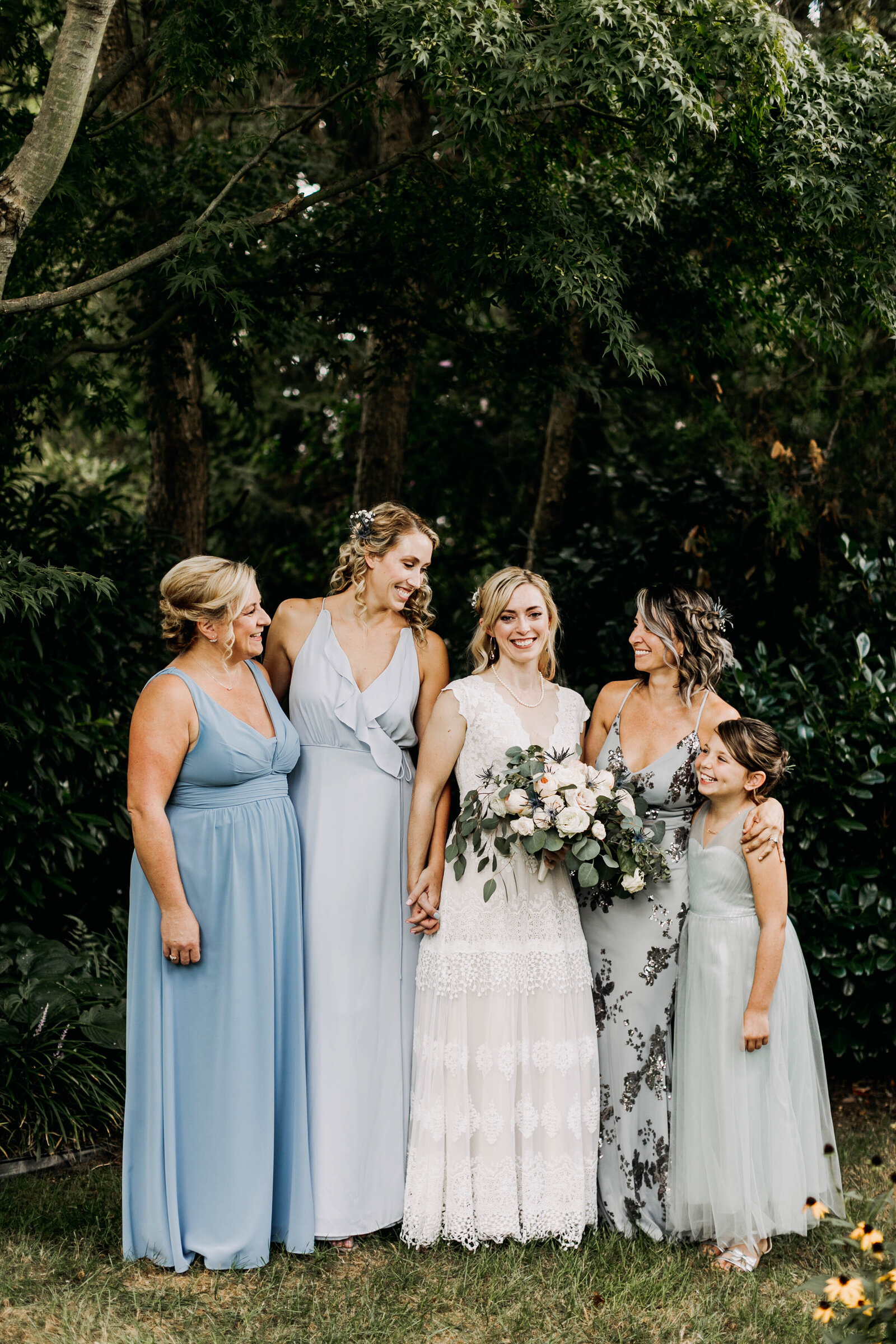 bridesmaids blue dresses in garden