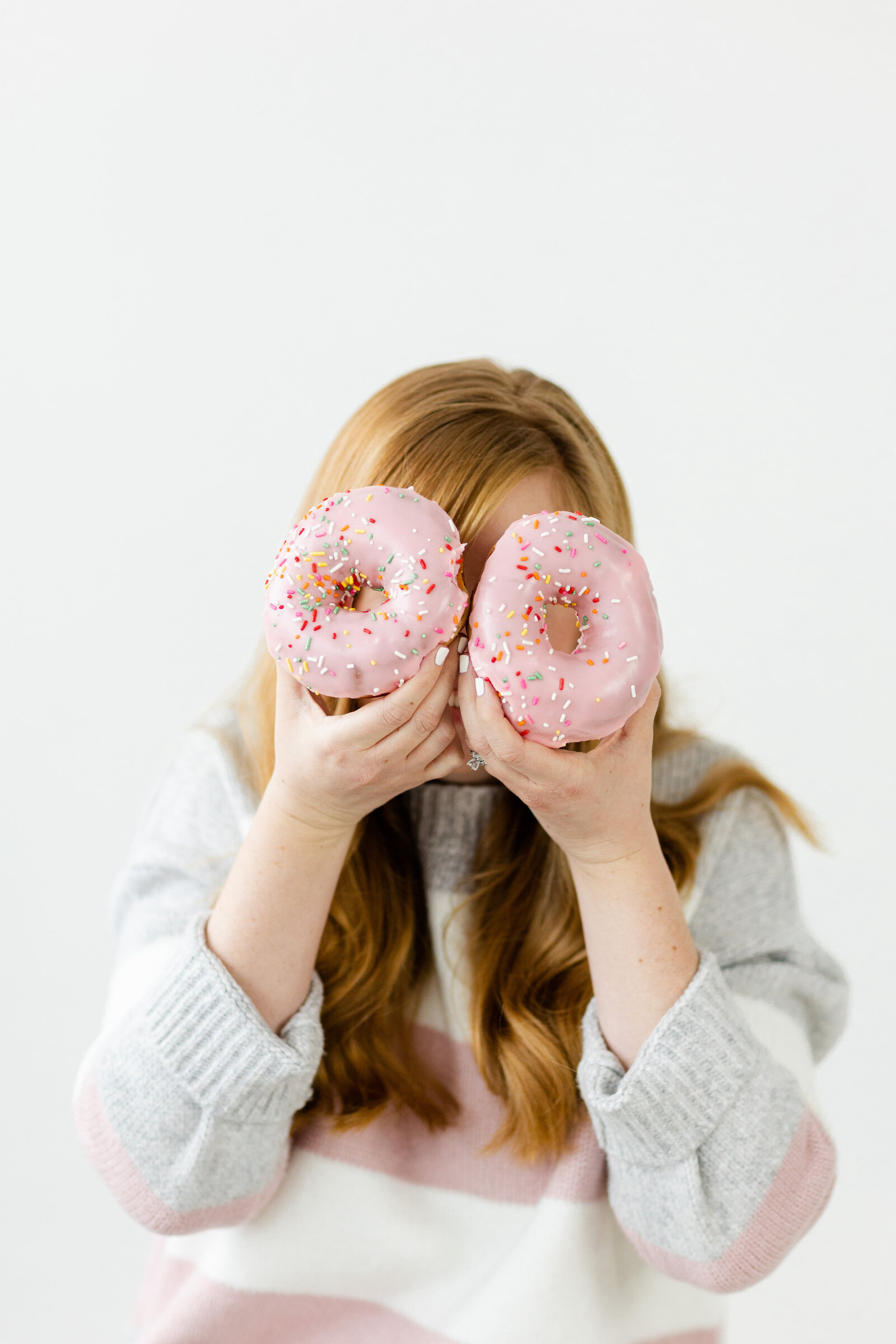 Ohio photographer posing with donuts for branding photos