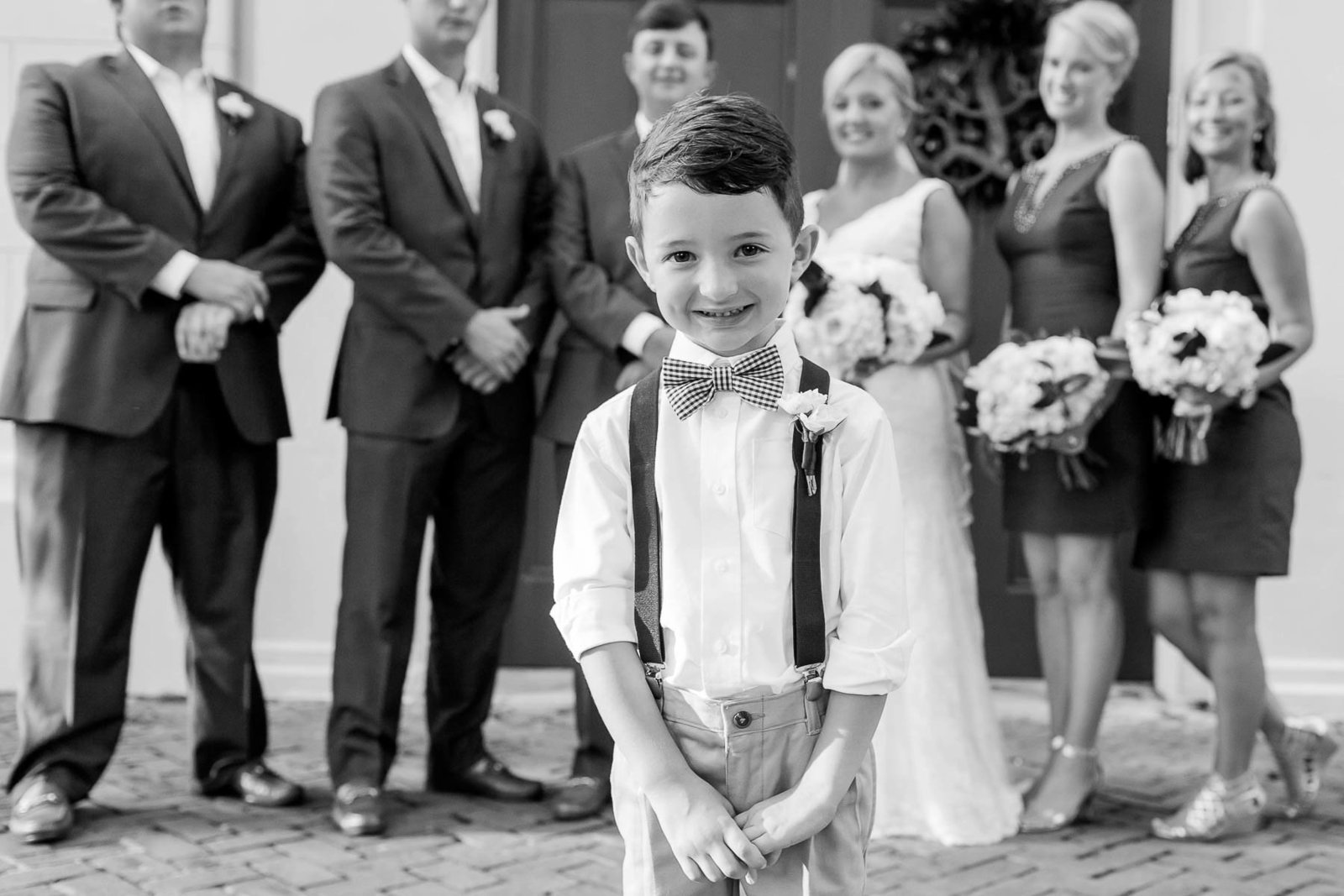 Ringbearer stands in forefront with wedding party behind him, Coleman Hall, Mt Pleasant, South Carolina