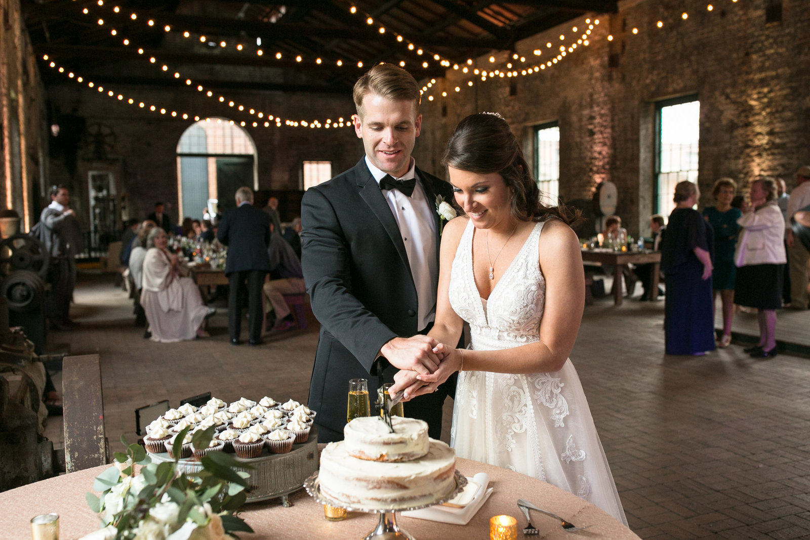 bride and groom cutting cake at roundhouse railroad museaum wedding savannah georgia