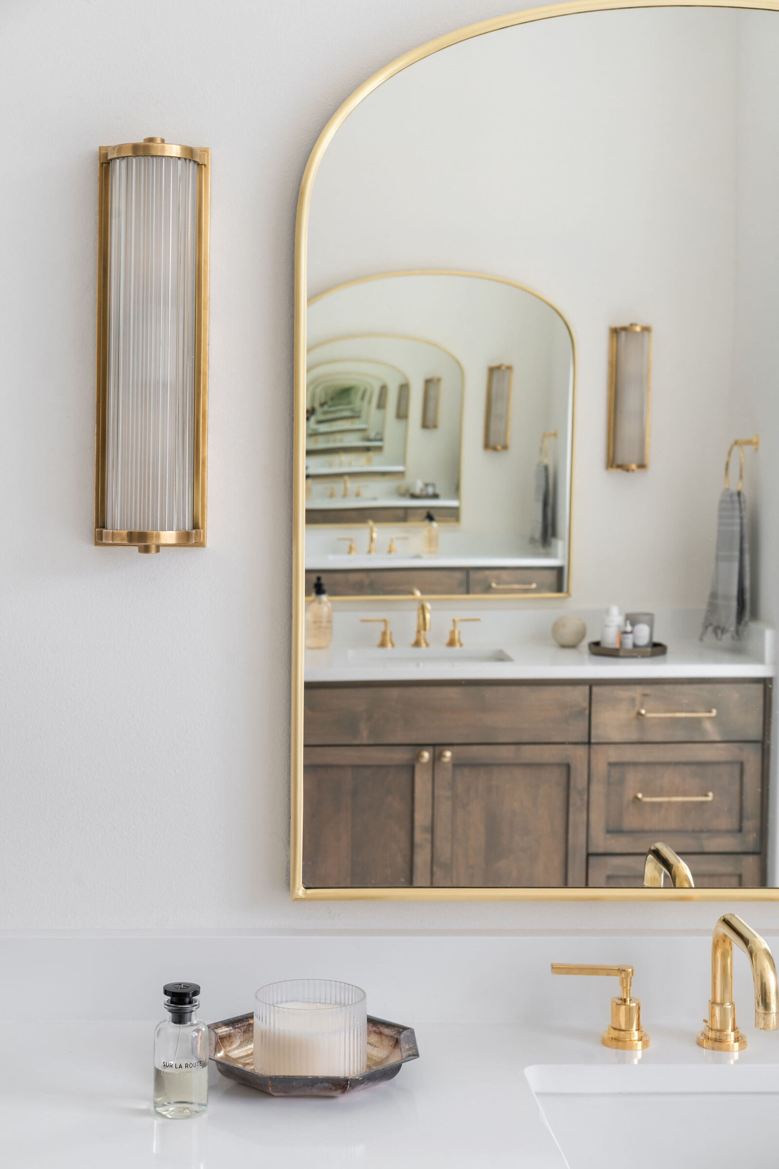 NuelaDesign_Brass Sconce and Brass Mirror Bathroom Design