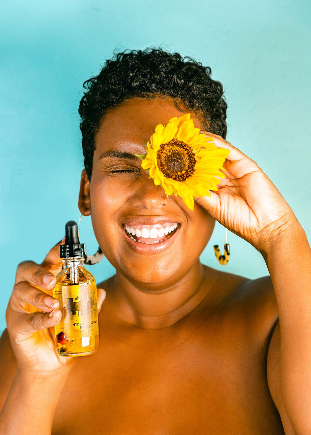 Chelsea Loren branding photographer skincare clean minimal boho black woman with sunflower natural