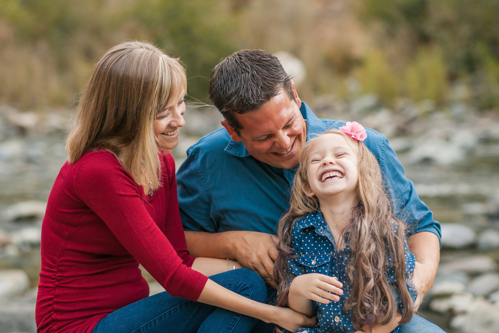 Colfax  family session family of three laughing at the river