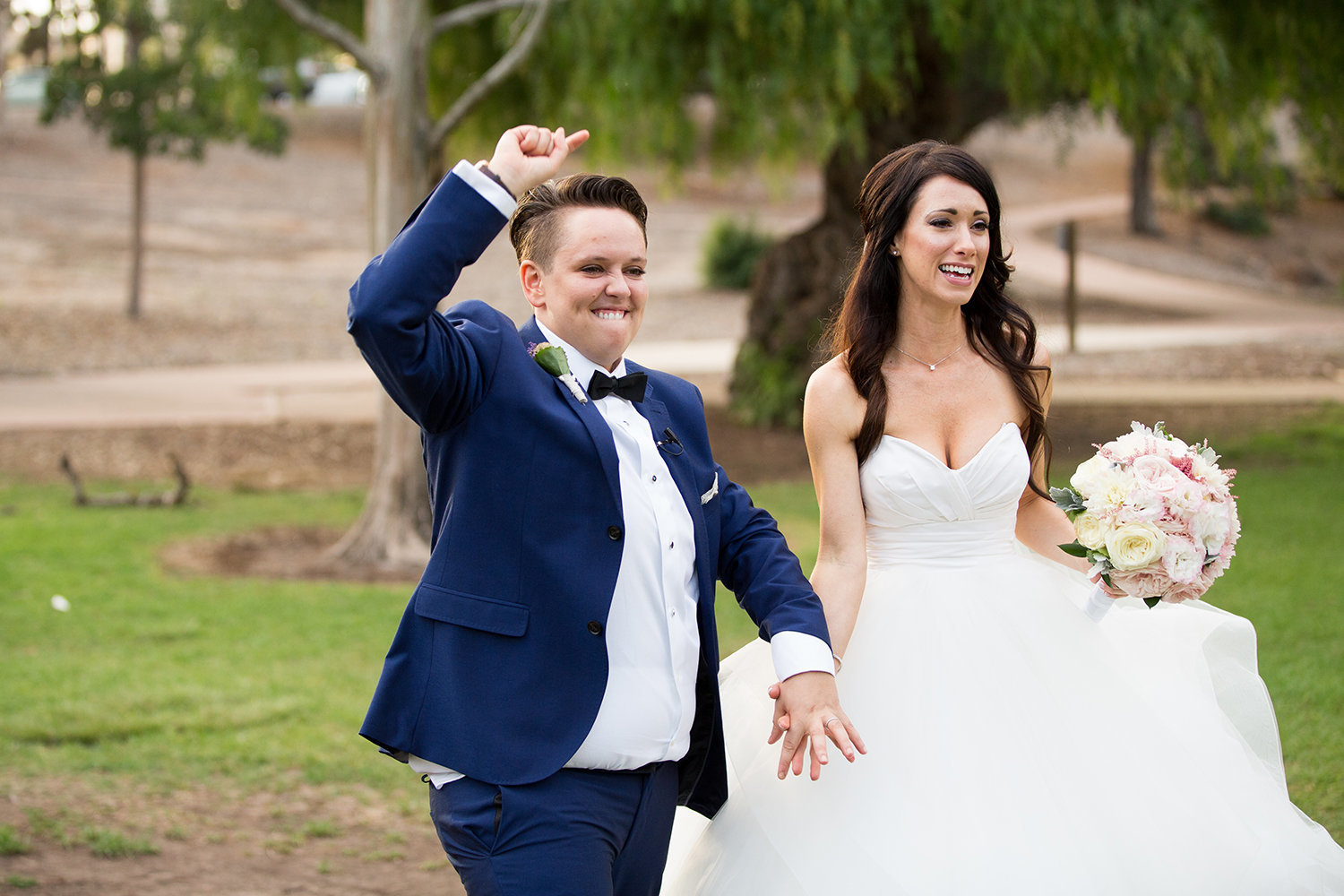 Married! Lets party.  Brides celebrate after their wedding ceremony at Balboa Park in San Diego | LGBT Wedding