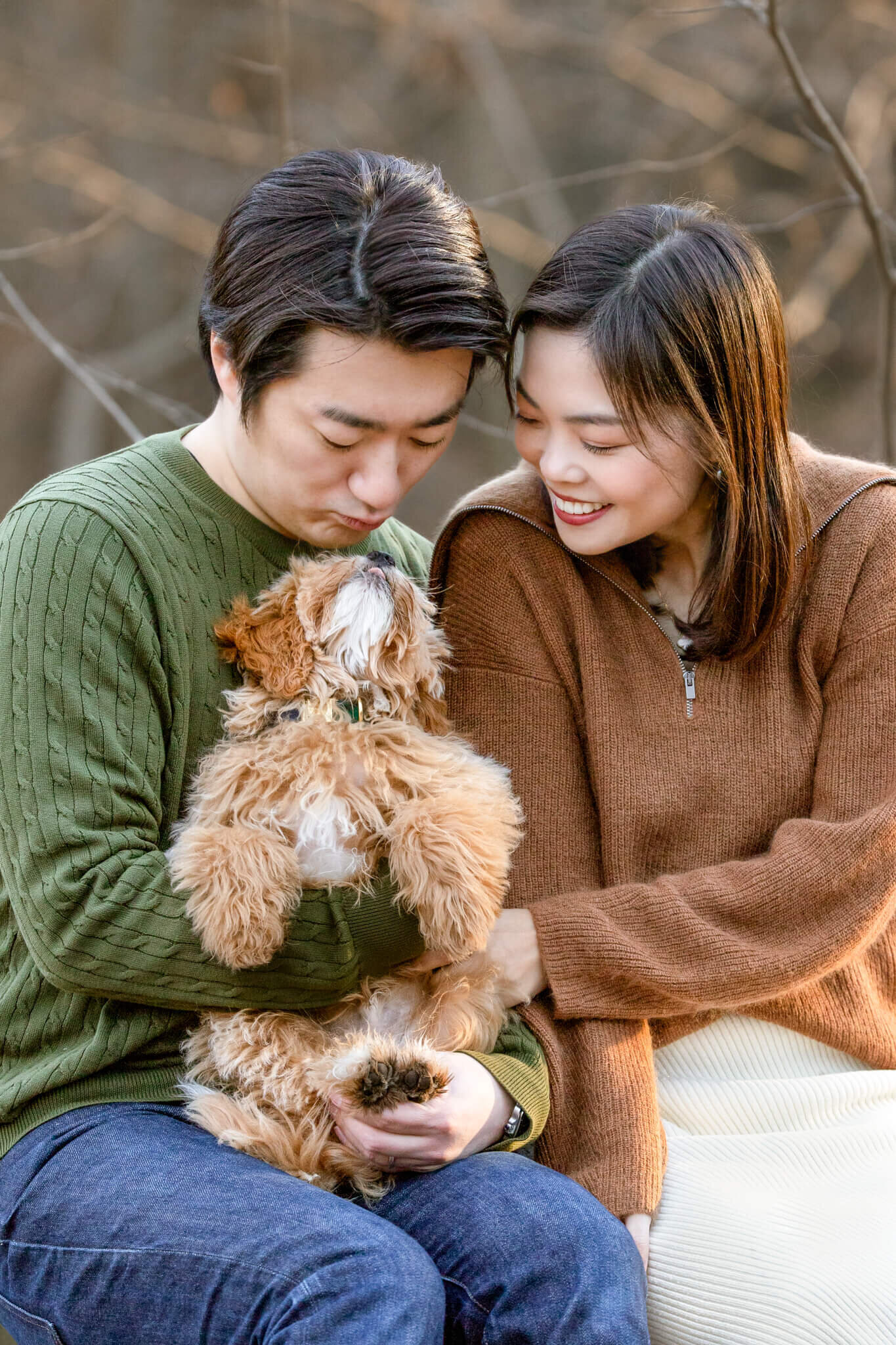 Gorgeous Boston couple smiling and snuggling their Golden Doodle puppy