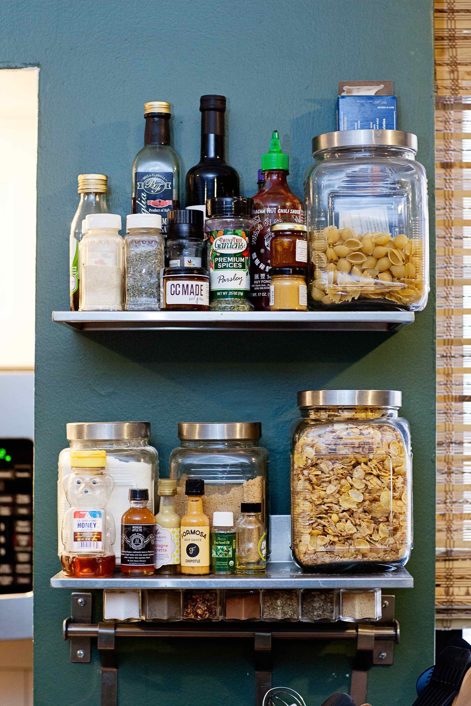 Floating shelves with spices and glass jars with foods.