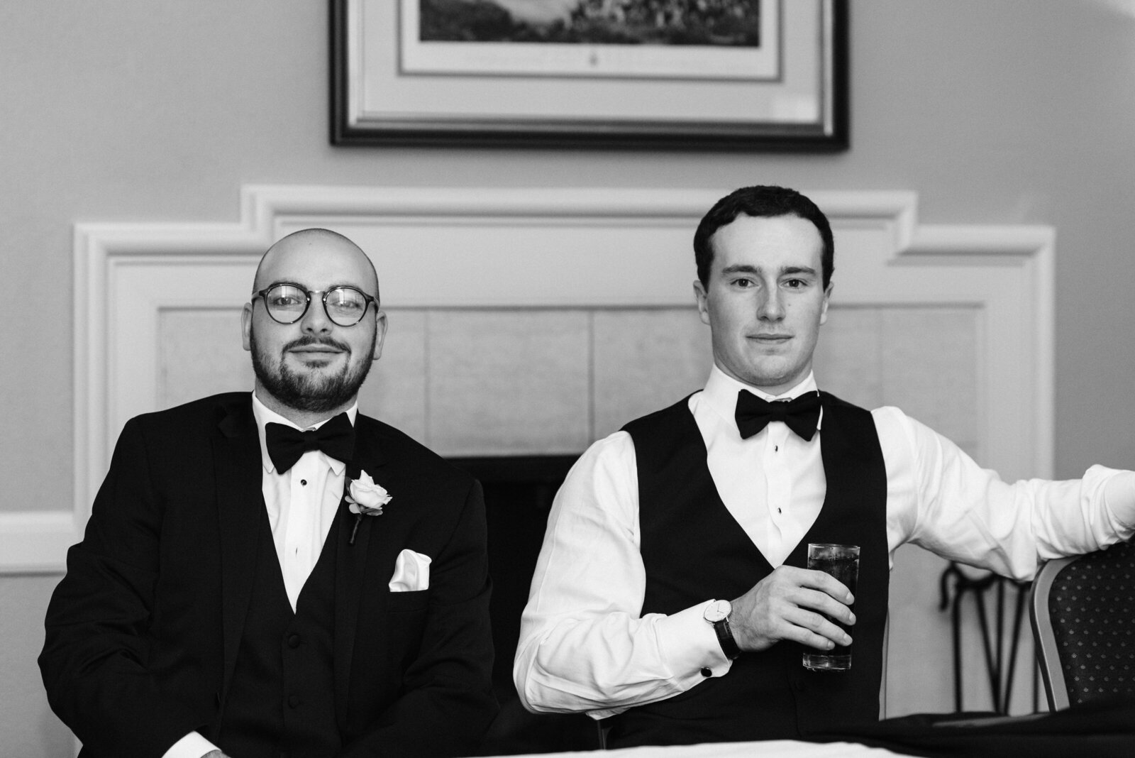 Groomsmen posing in front of the camera while sitting