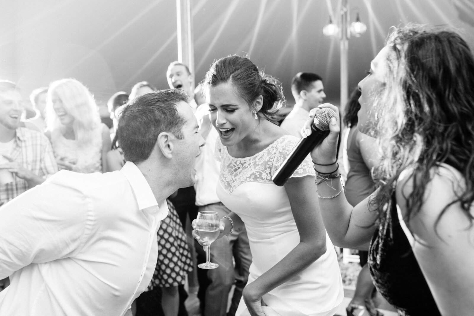bride and groom sing on reception dance floor