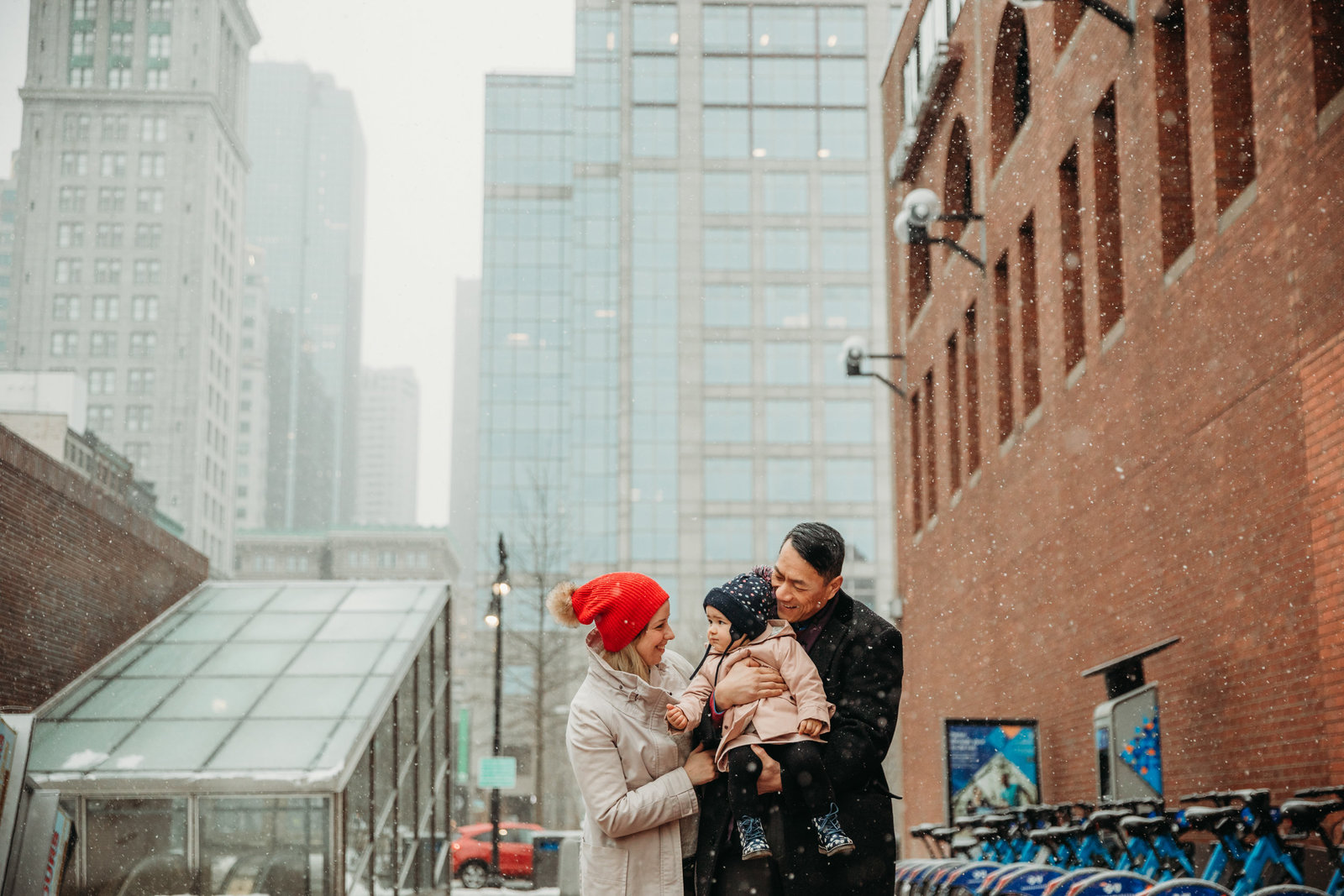 family in winter hats snuggle for winter snow session in boston