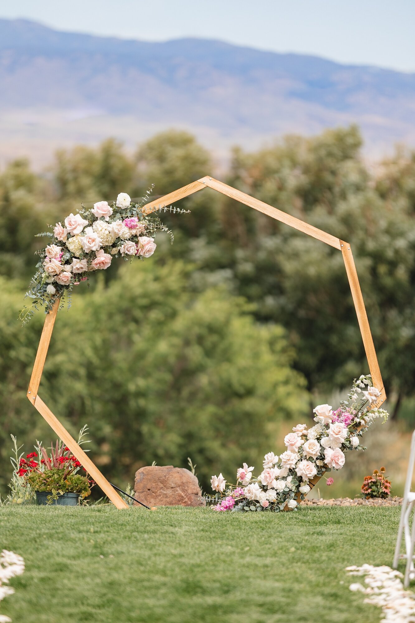 hexagon wedding arch with pink and ivory flowers