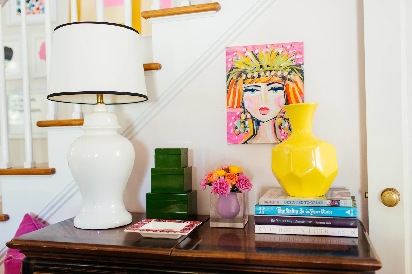 A side table with a white lamp and accessories.