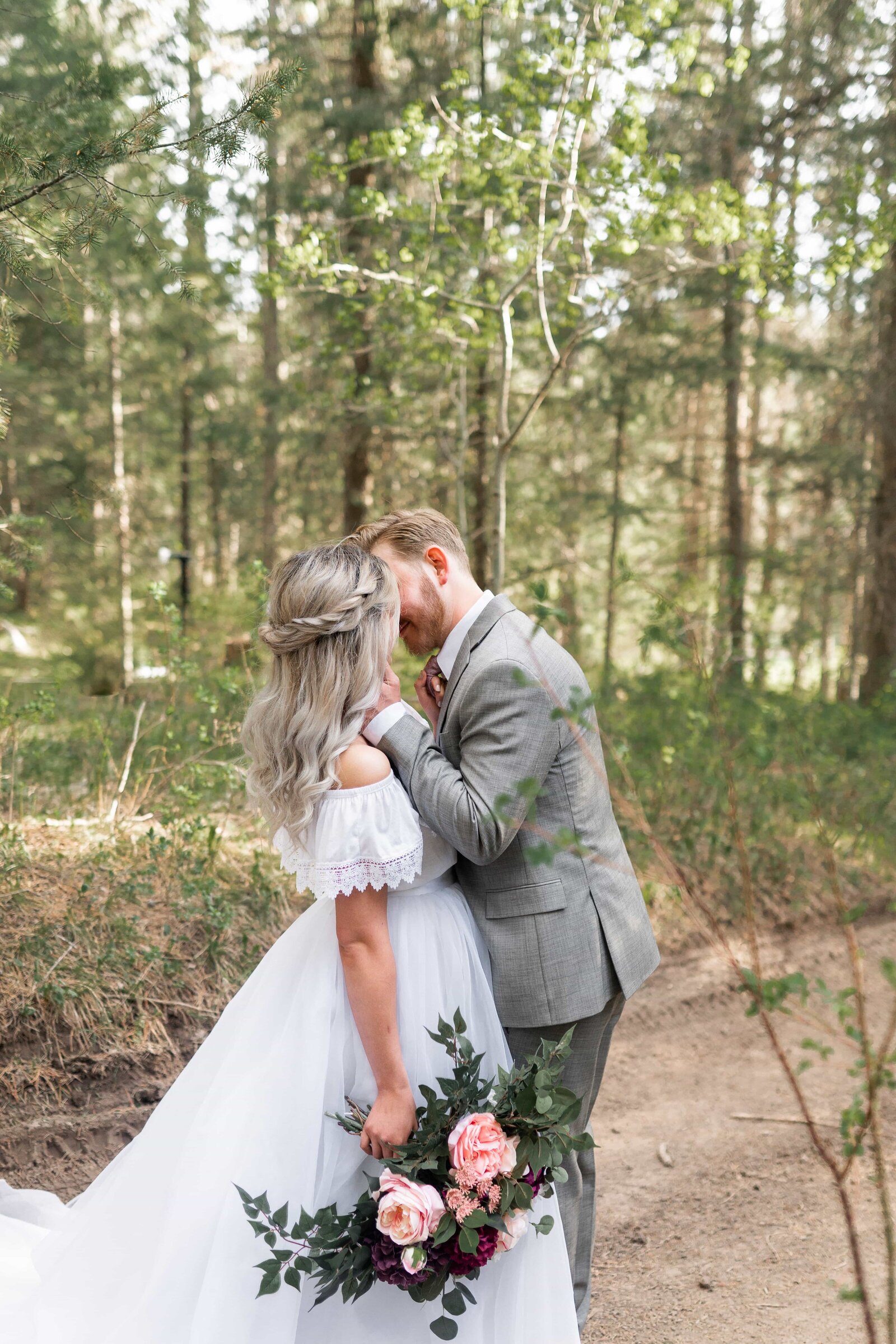 Lake Tahoe wedding photographer captures couple kissing during forest bridals