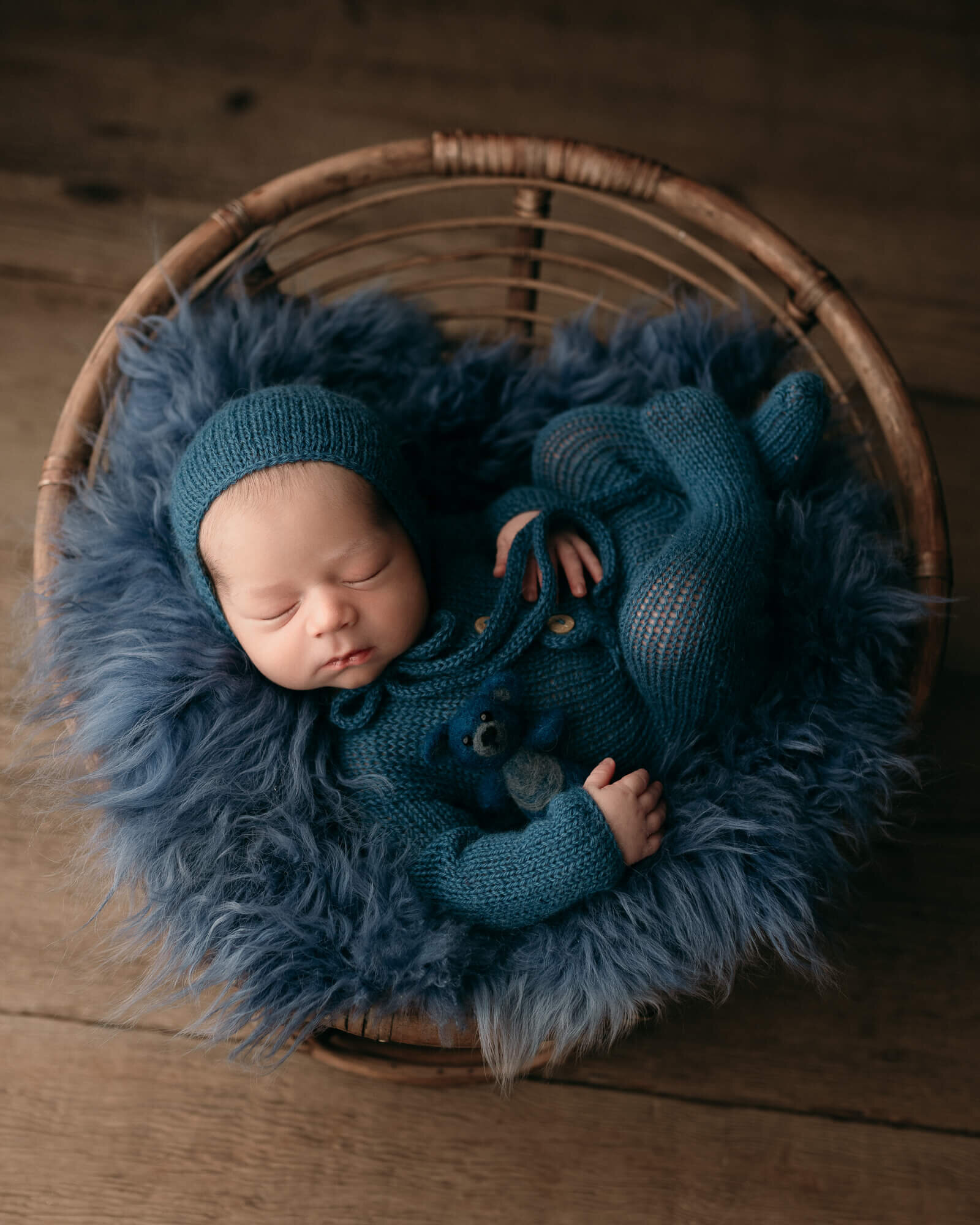 picture of baby boy in blue on papasan chair