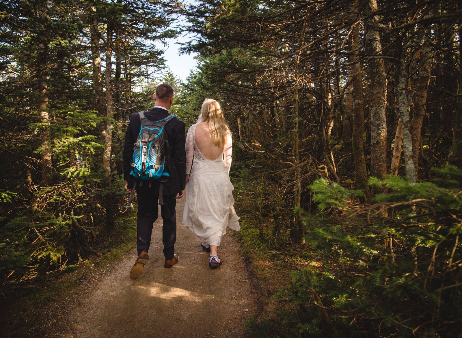 eloping couple walking in the woods
