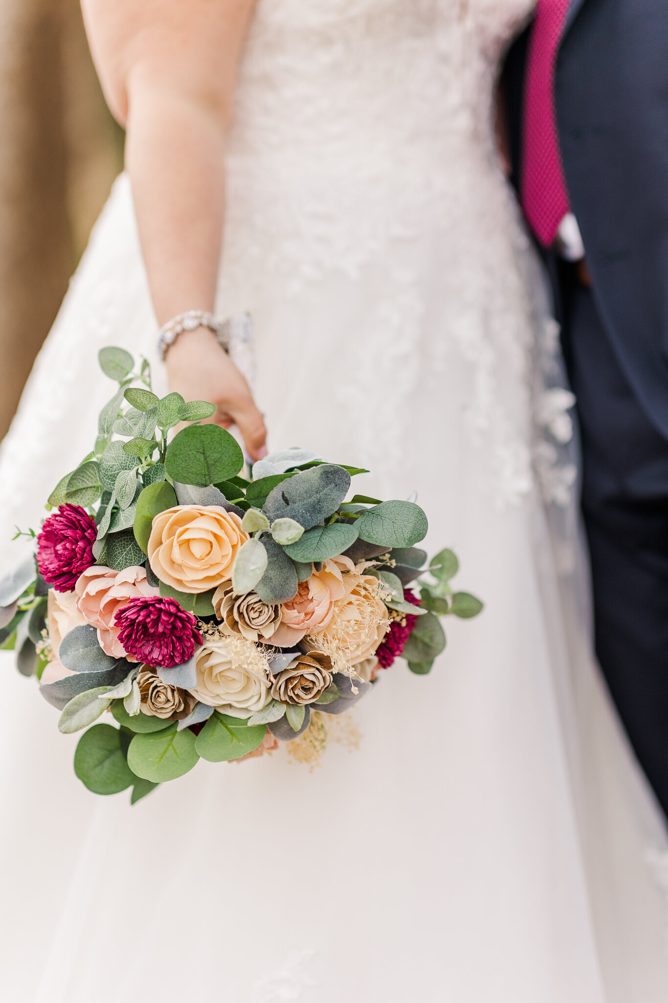 image of bride holding down bouquet