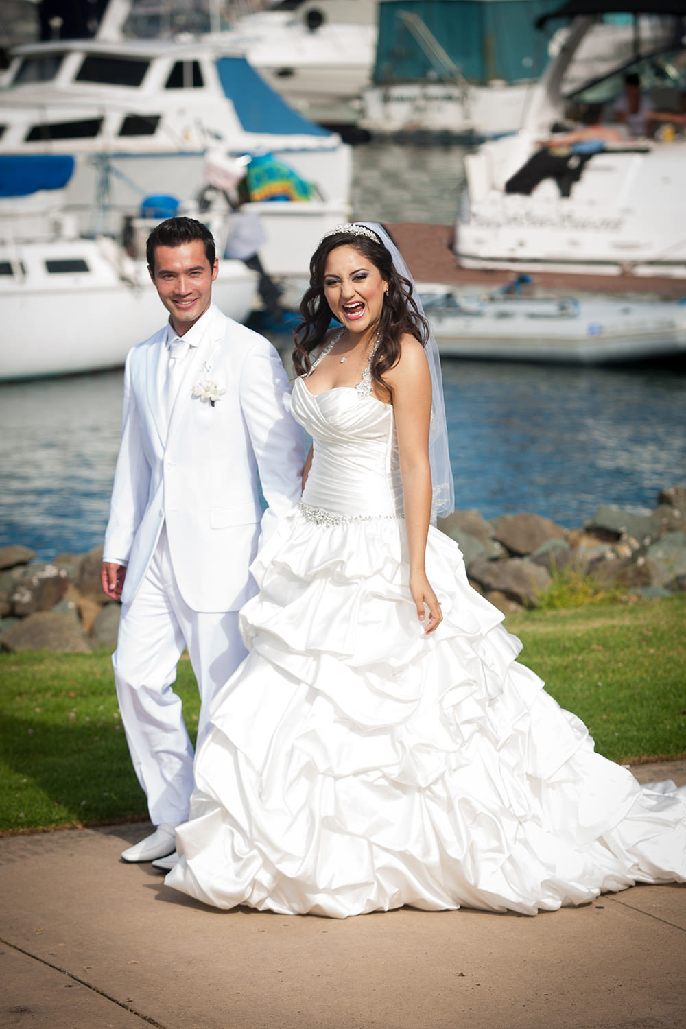 bride and groom walking by the boats