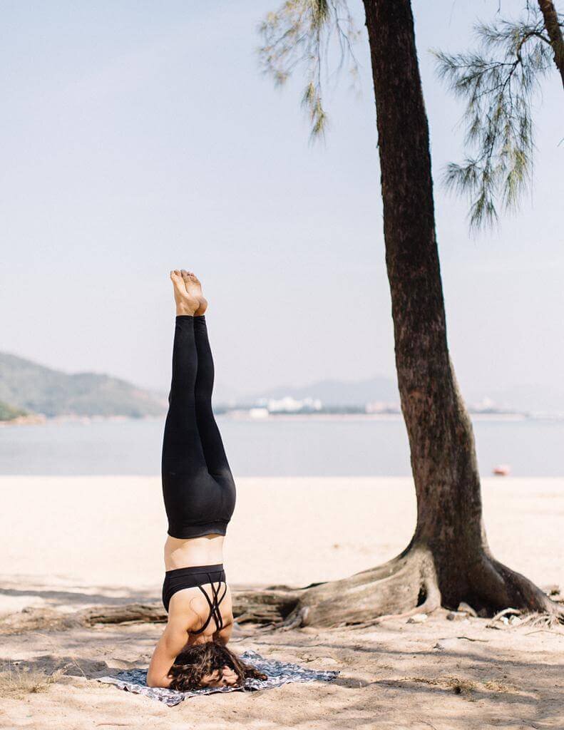 Women doing yoga at the beach for an branding photography session.