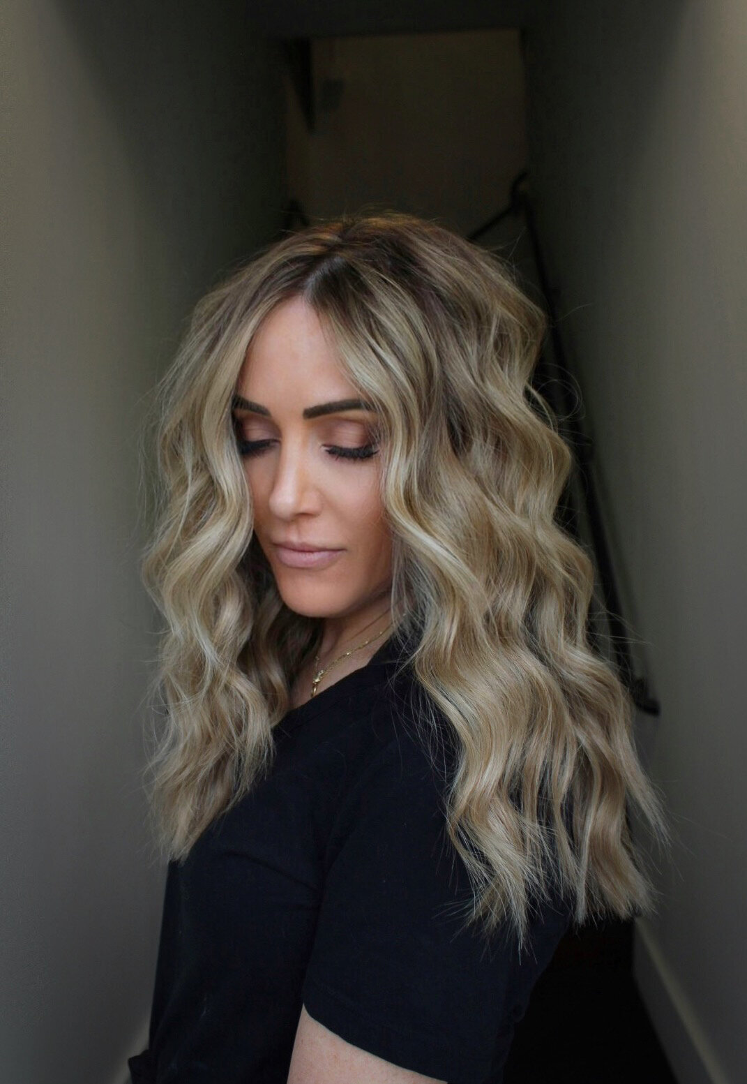 Side profile of a woman with ash blonde wavy hair