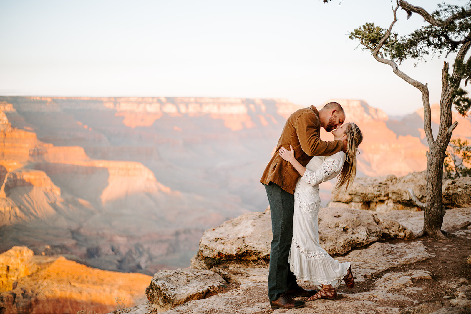 Couple kissing and groom dipping his wife back during his Grand Canyon Elopement