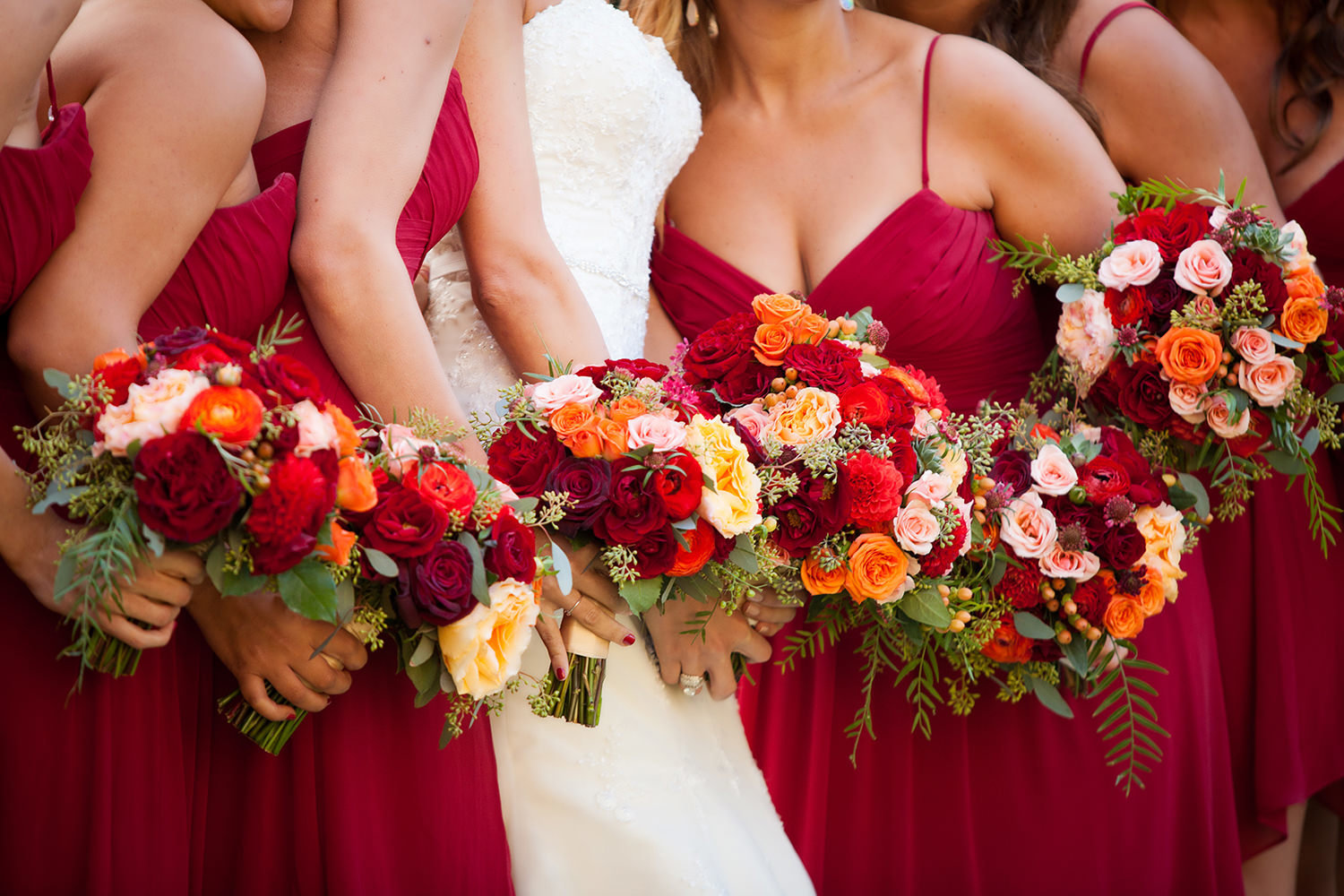 Brightly colored wedding bouquets and dresses