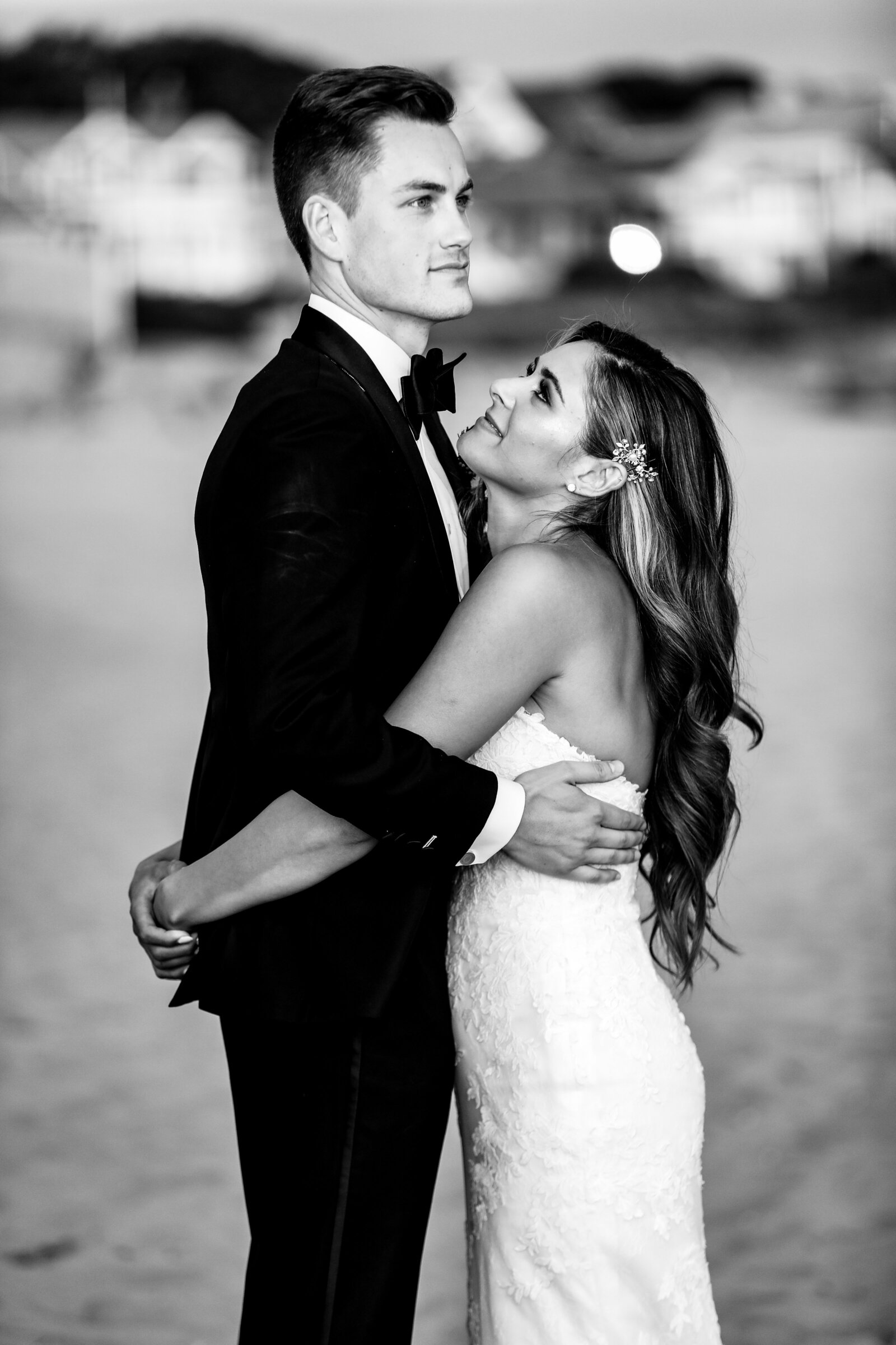 bride and groom embrace at newport beach house