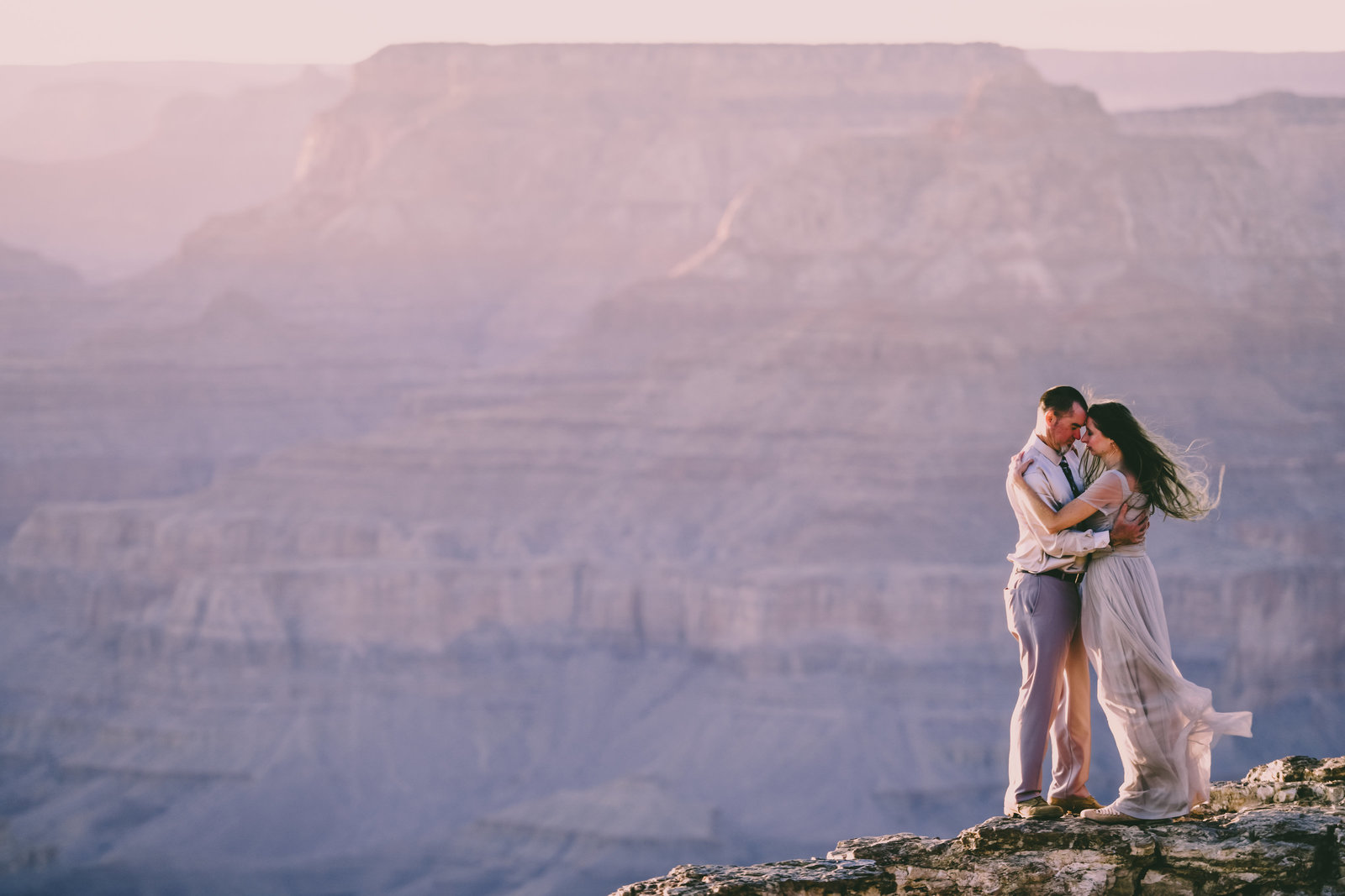 Elopement couple on a rocky ledge at Grand Canyon National Park's South Rim