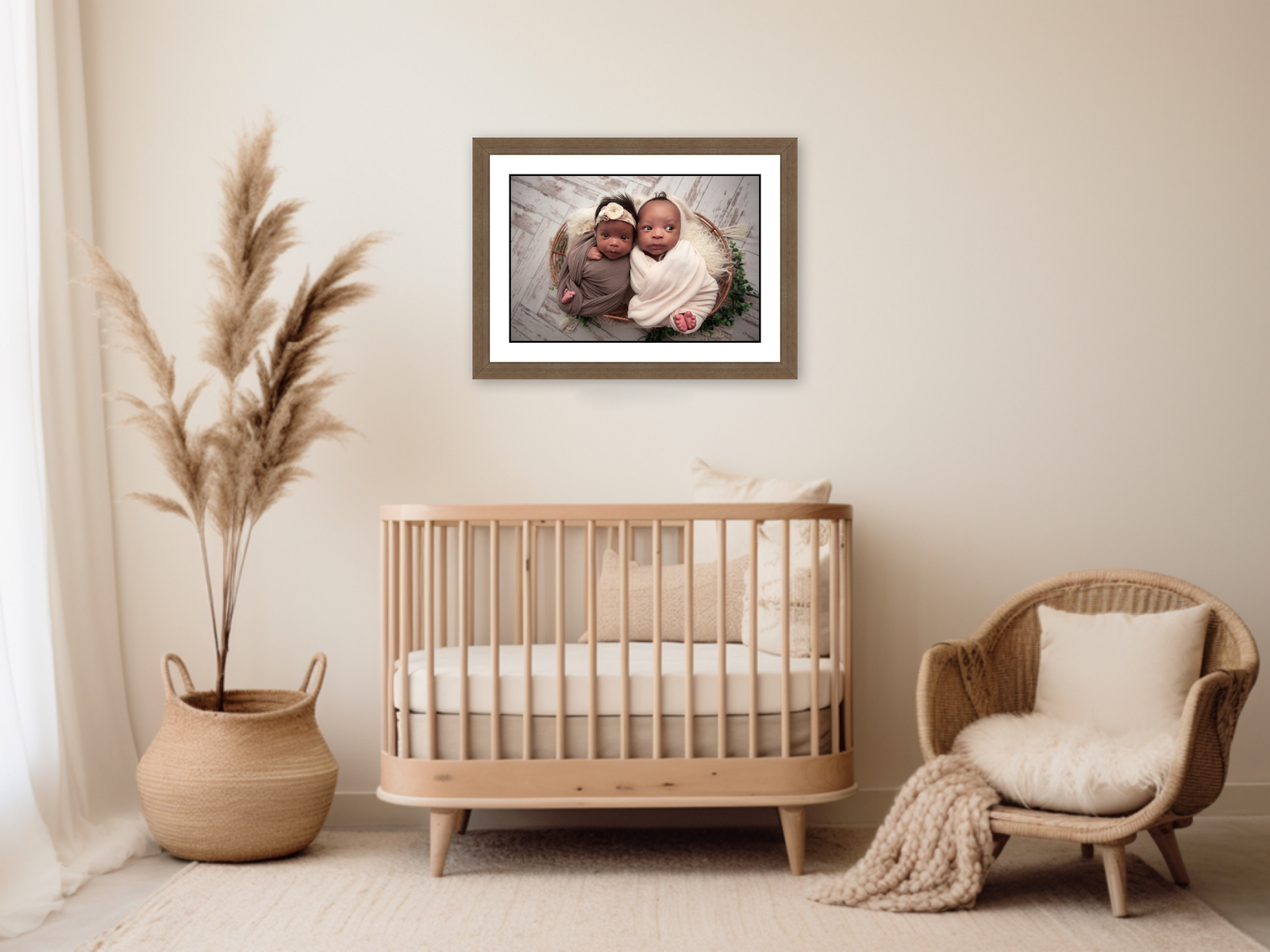 Nursery with a framed print of newborn twins above the crib