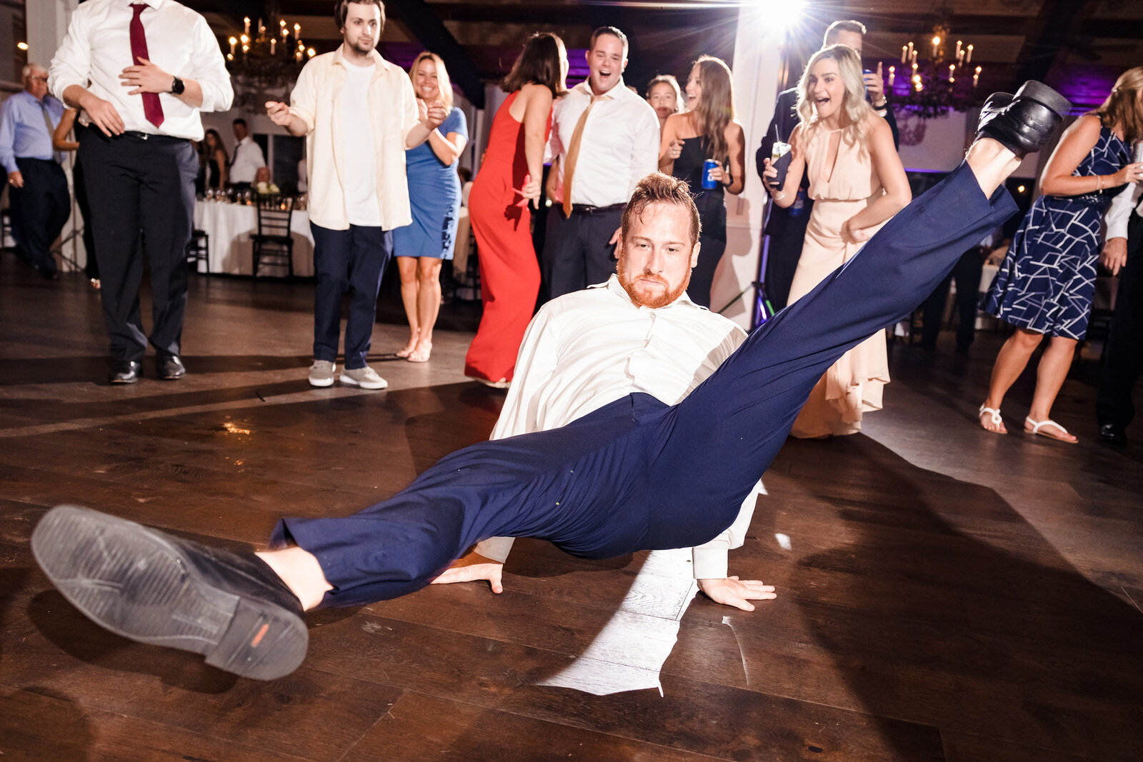 groom does split on wedding dance floor