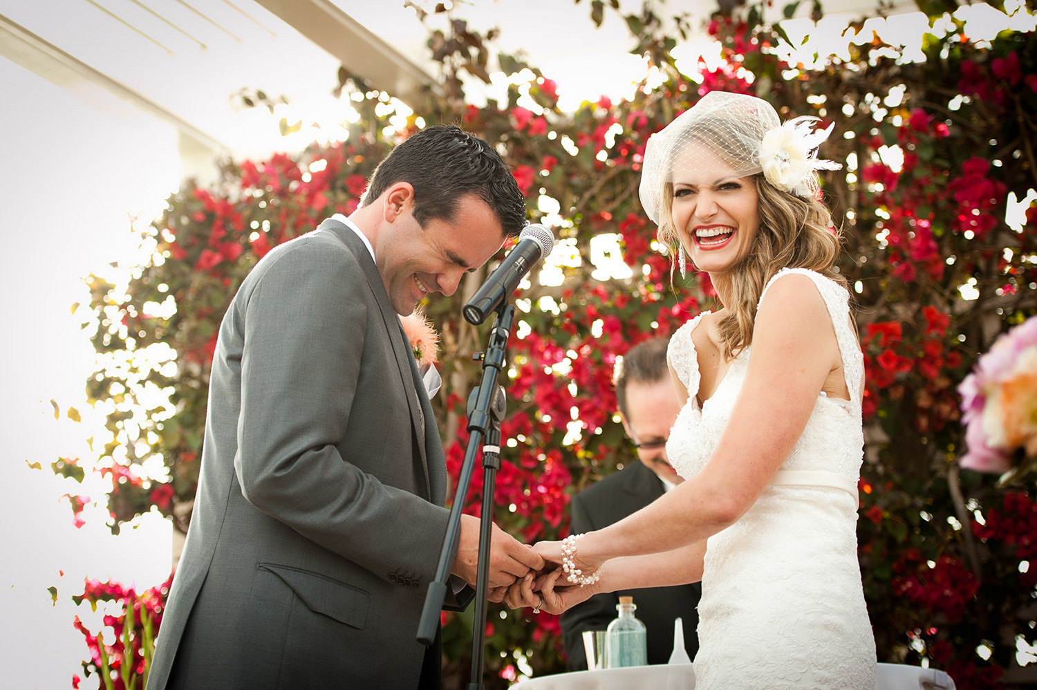 Bride laughing at ceremony with groom