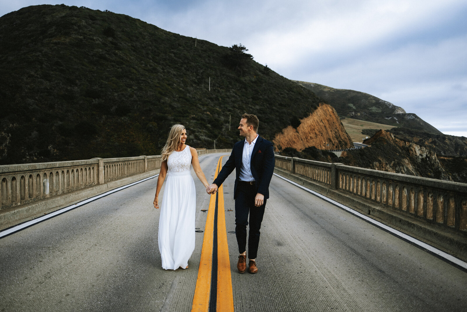 Couple Walking Alone Bixby Bridge in Big Sur