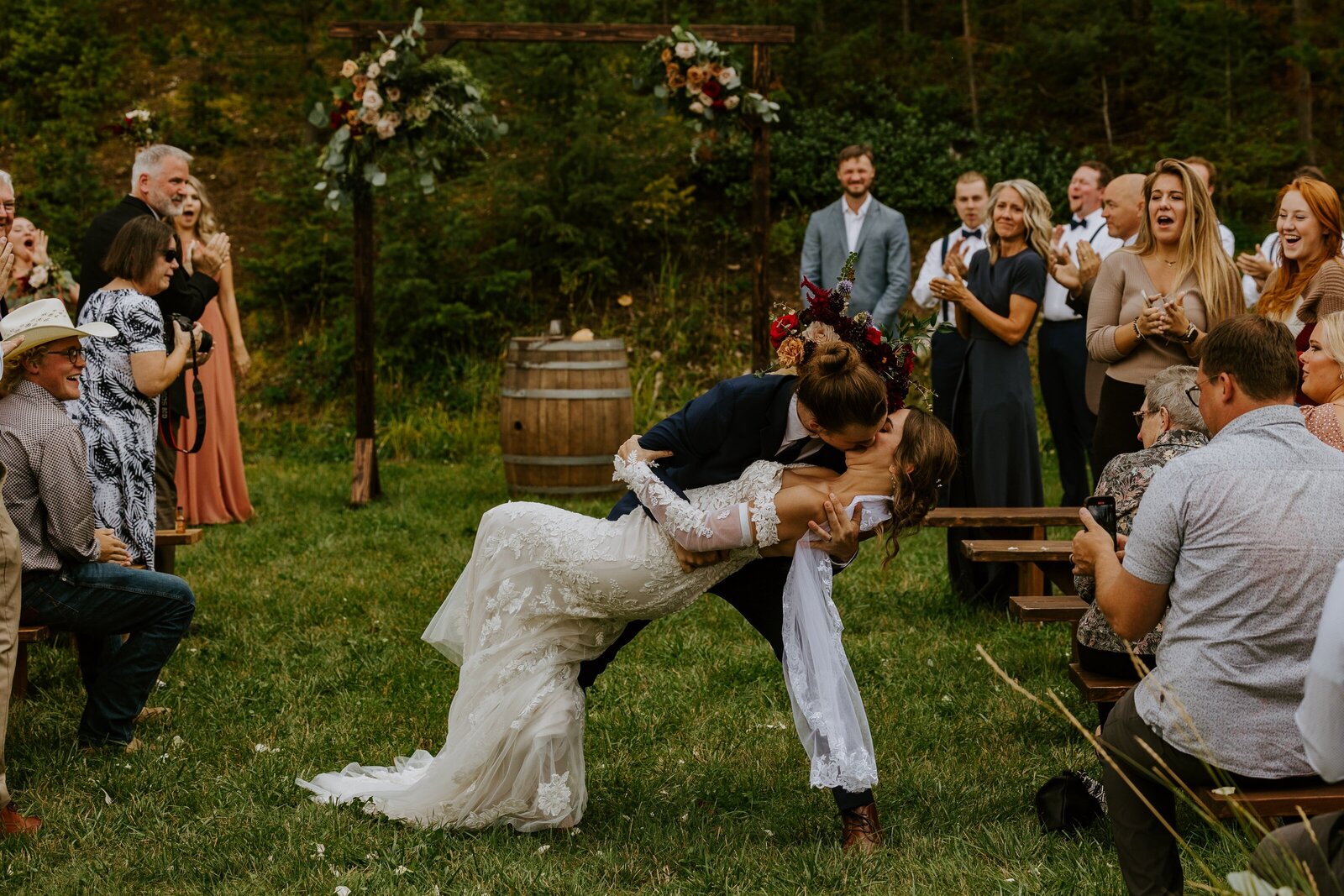 Groom kisses the bride during their wedding at the commons.