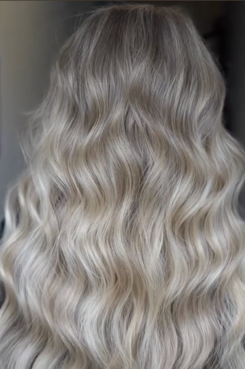 Rear view of thick, wavy blonde hair with natural highlights