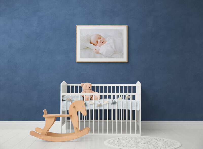 White_wooden_cot_and_rocking_horse_in_nursery