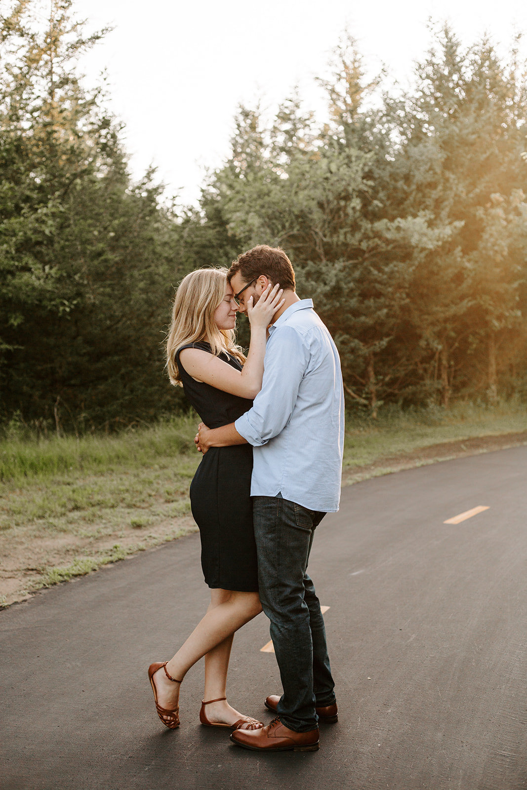 Couple with their arms around each other on a path during their Minneapolis engagement session