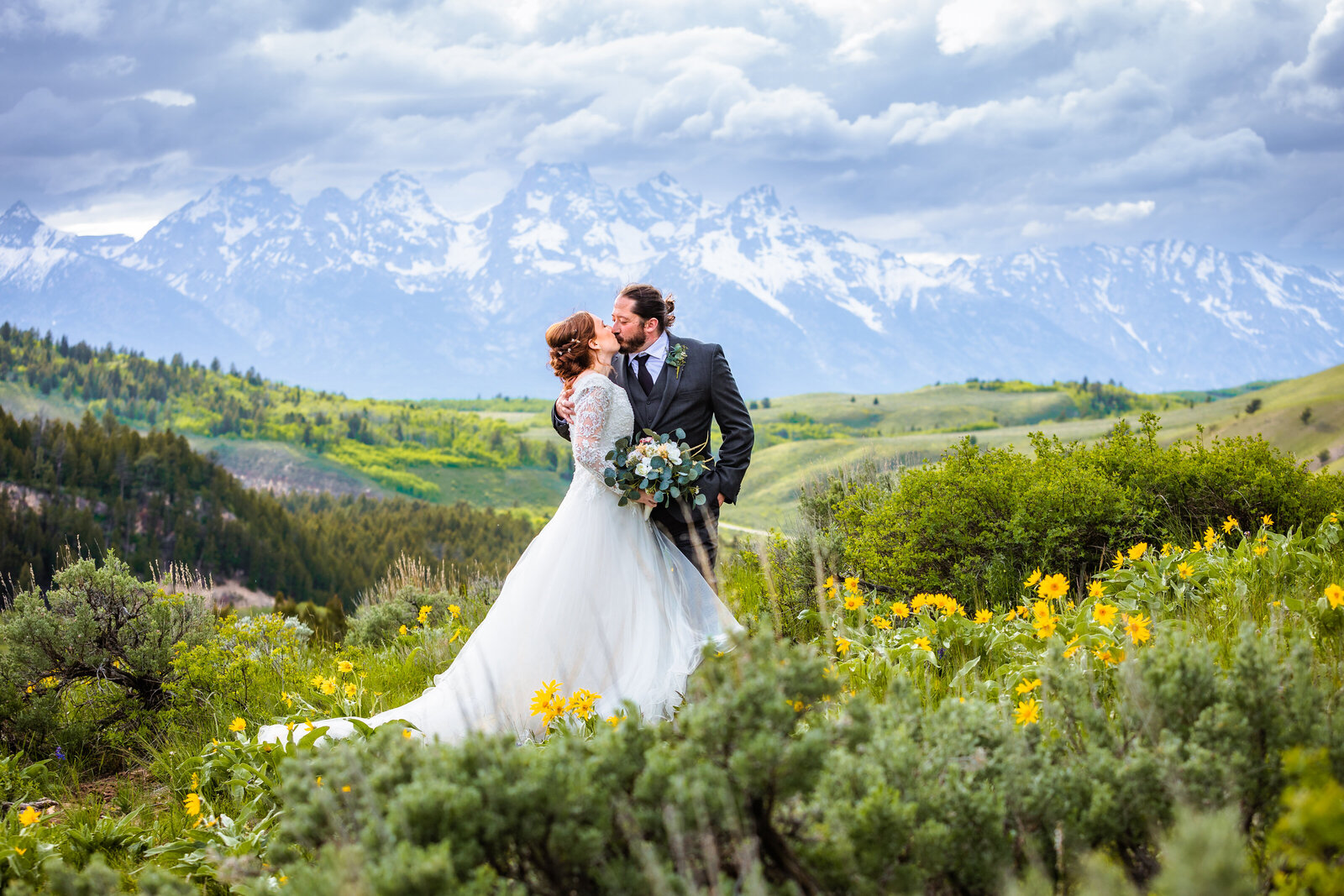 Jackson Hole photographers capture bride and groom kissing after wedding