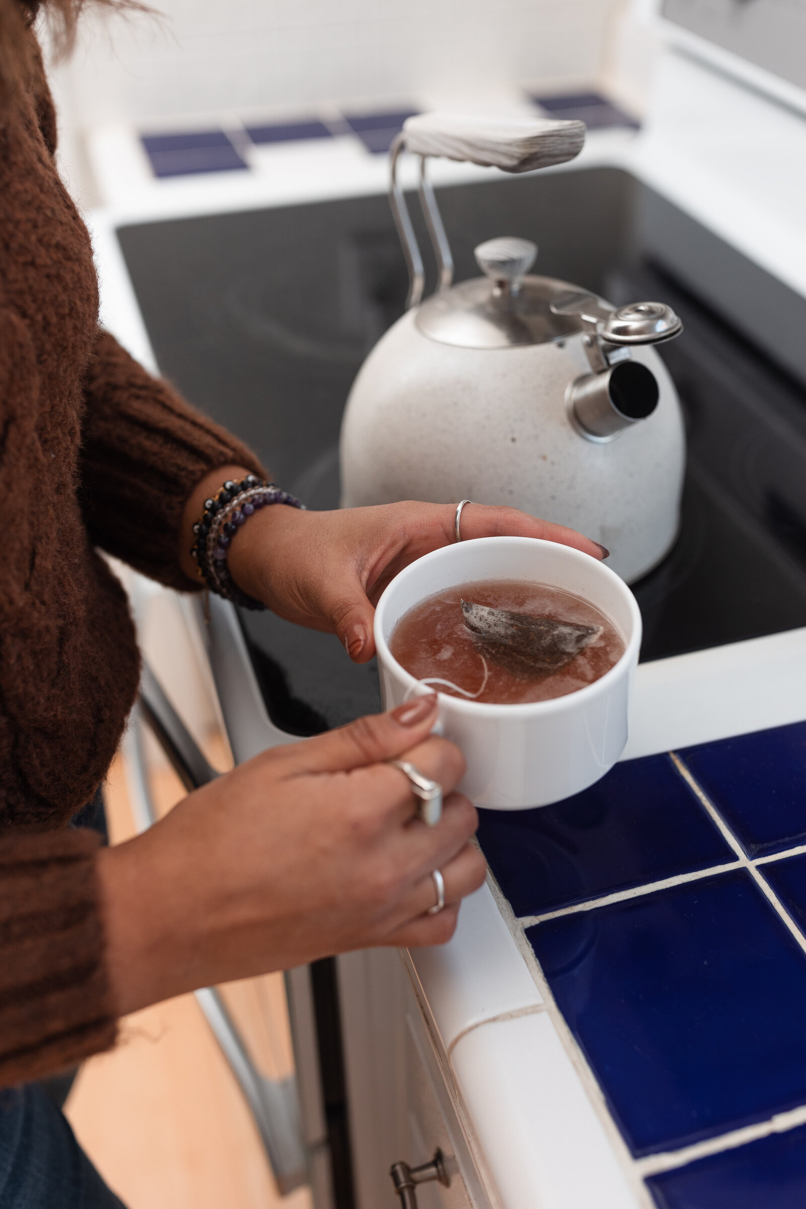 woman preparing mug of tea