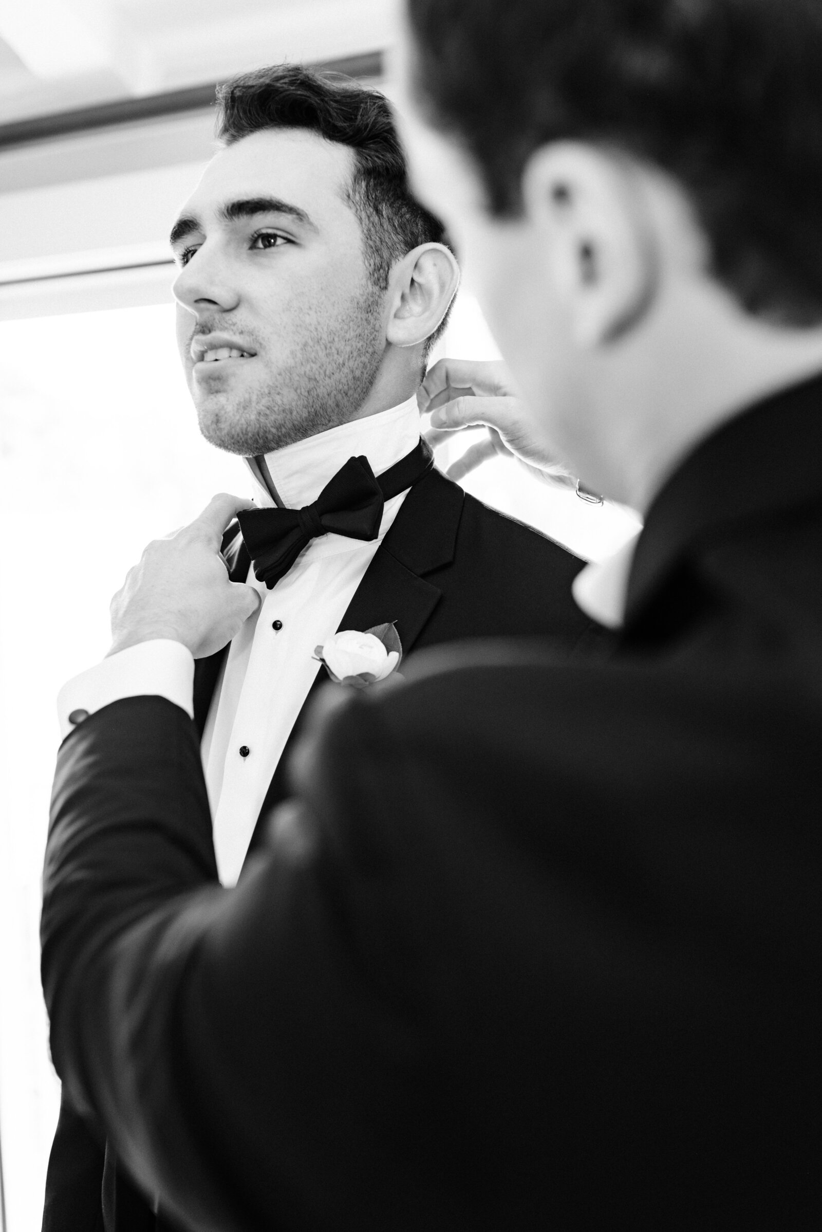 Groom getting ready with his bowtie