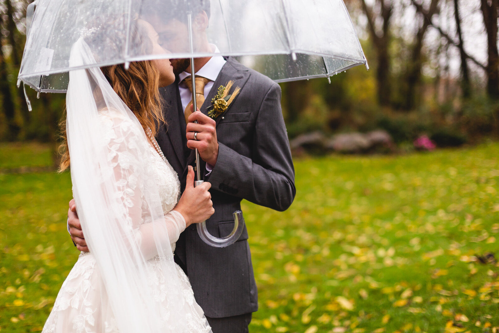 rainy wedding portraits with bride and groom and clear umbrella ohio