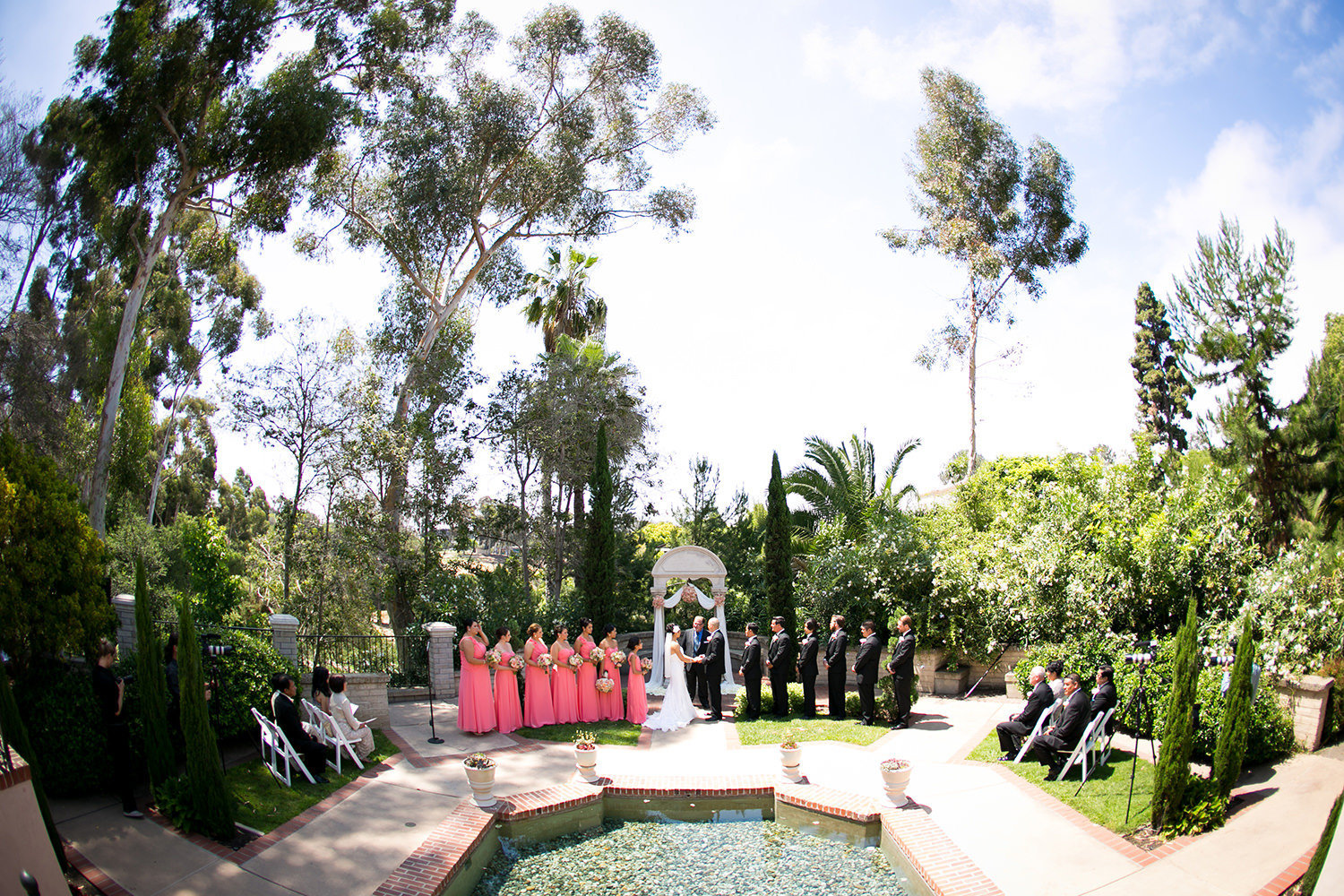 bride and groom at ceremony wishing well the prado