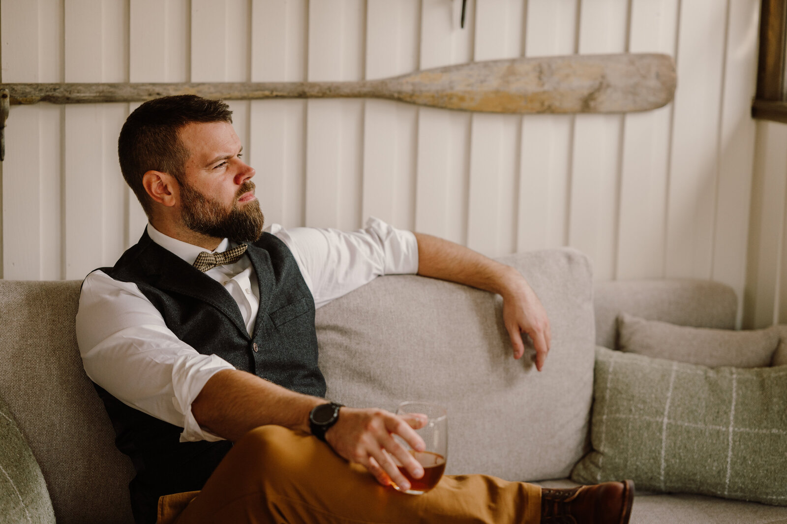 Groom wore wool vest, plaid bowtie with tan jeans and red wing boots