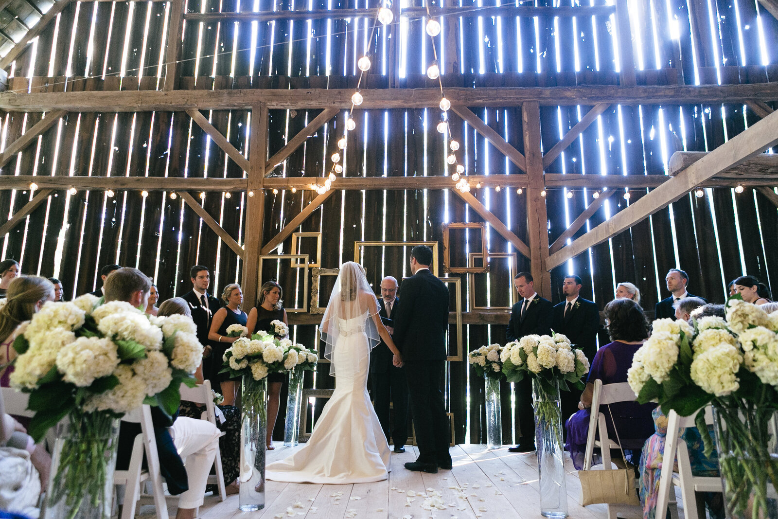 bride and groom ceremony in barn